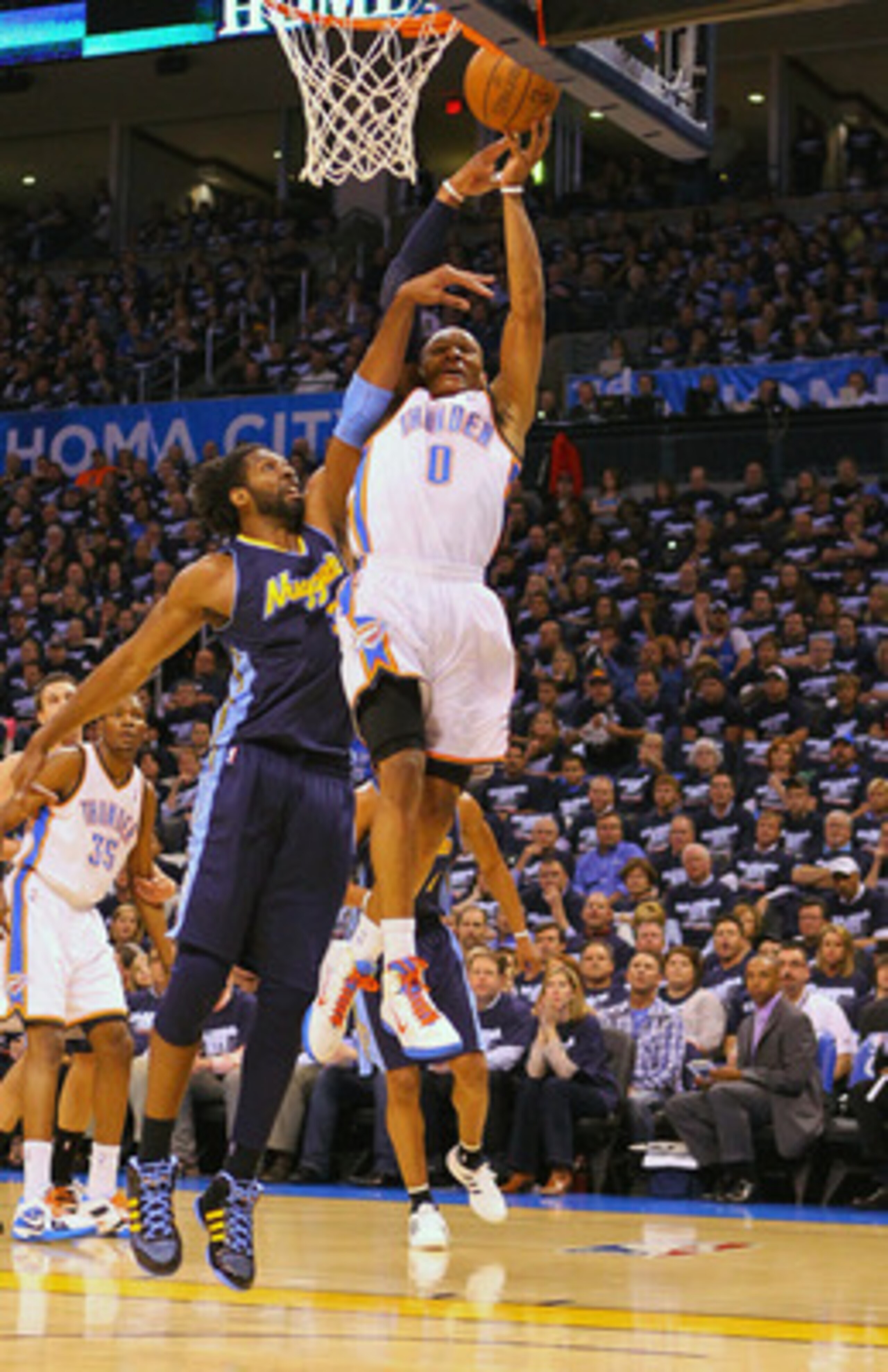 OKLAHOMA CITY, OK - APRIL 27: Russell Westbrook #0 of the Oklahoma City Thunder attempts to dunk the ball against Nene Hilario #31 of the Denver Nuggets in Game Five of the Western Conference Quarterfinals in the 2011 NBA Playoffs on April 27, 2011 at the