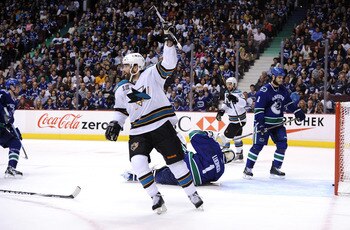 VANCOUVER, BC - MAY 15:  Patrick Marleau #12 and Devin Setoguchi #16 of the San Jose Sharks react after a goal by teammate Joe Thornton #19 (not in photo) as Kevin Bieksa #3 of the Vancouver Canucks looks on in the first period in Game One of the Western 