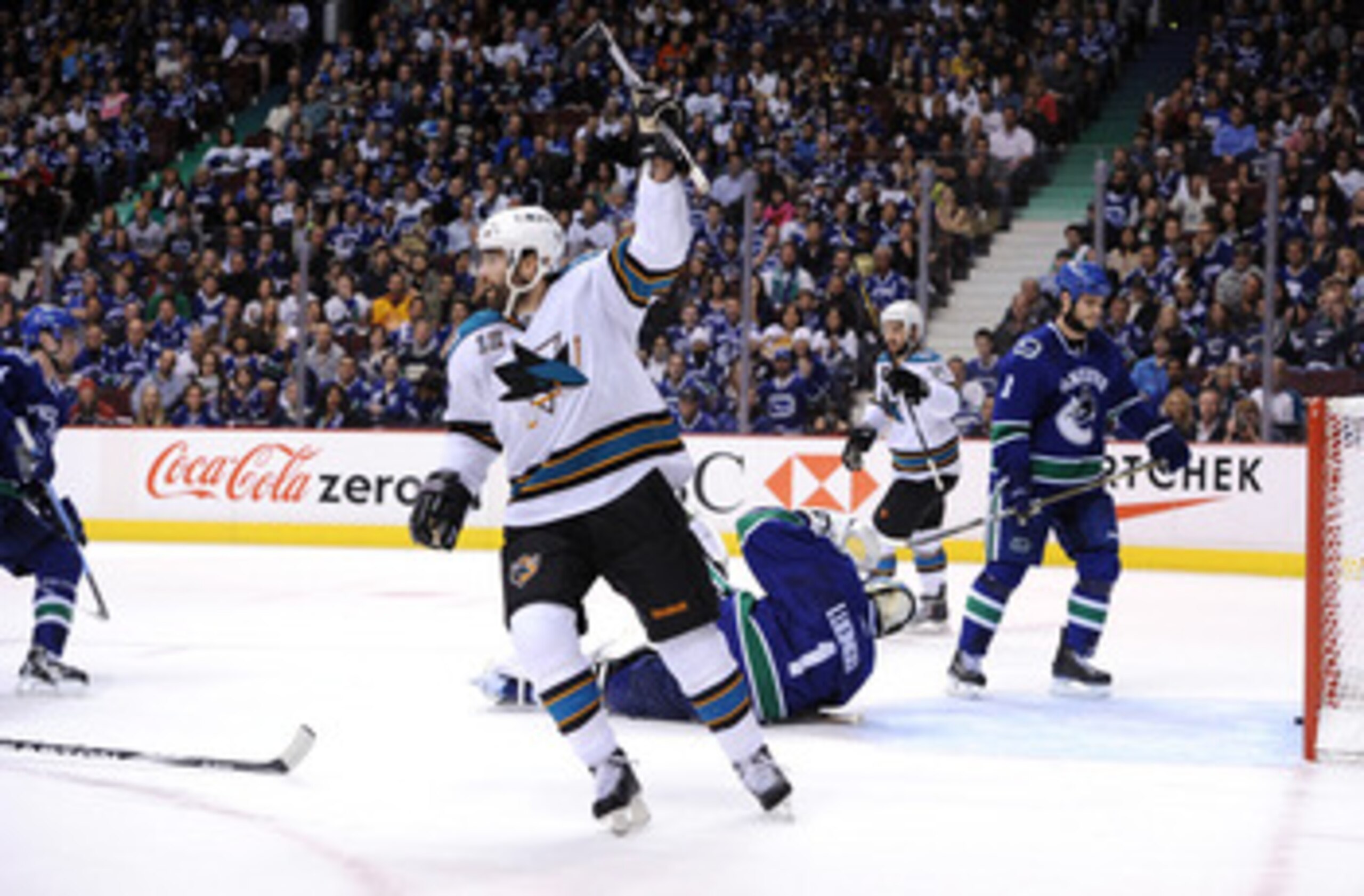 VANCOUVER, BC - MAY 15: Patrick Marleau #12 and Devin Setoguchi #16 of the San Jose Sharks react after a goal by teammate Joe Thornton #19 (not in photo) as Kevin Bieksa #3 of the Vancouver Canucks looks on in the first period in Game One of the Western VANCOUVER, BC - MAY 15: Patrick Marleau #12 and Devin Setoguchi #16 of the San Jose Sharks react after a goal by teammate Joe Thornton #19 (not in photo) as Kevin Bieksa #3 of the Vancouver Canucks looks on in the first period in Game One of the Western