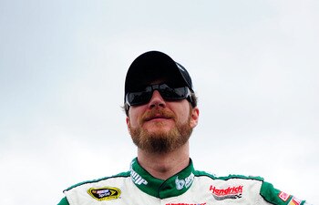 DOVER, DE - MAY 15:  Dale Earnhardt Jr., driver of the #88 Amp Energy Sugar Free/National Guard Chevrolet, stands on the grid prior to the NASCAR Sprint Cup Series FedEx 400 Benefiting Autism Speaks at Dover International Speedway on May 15, 2011 in Dover