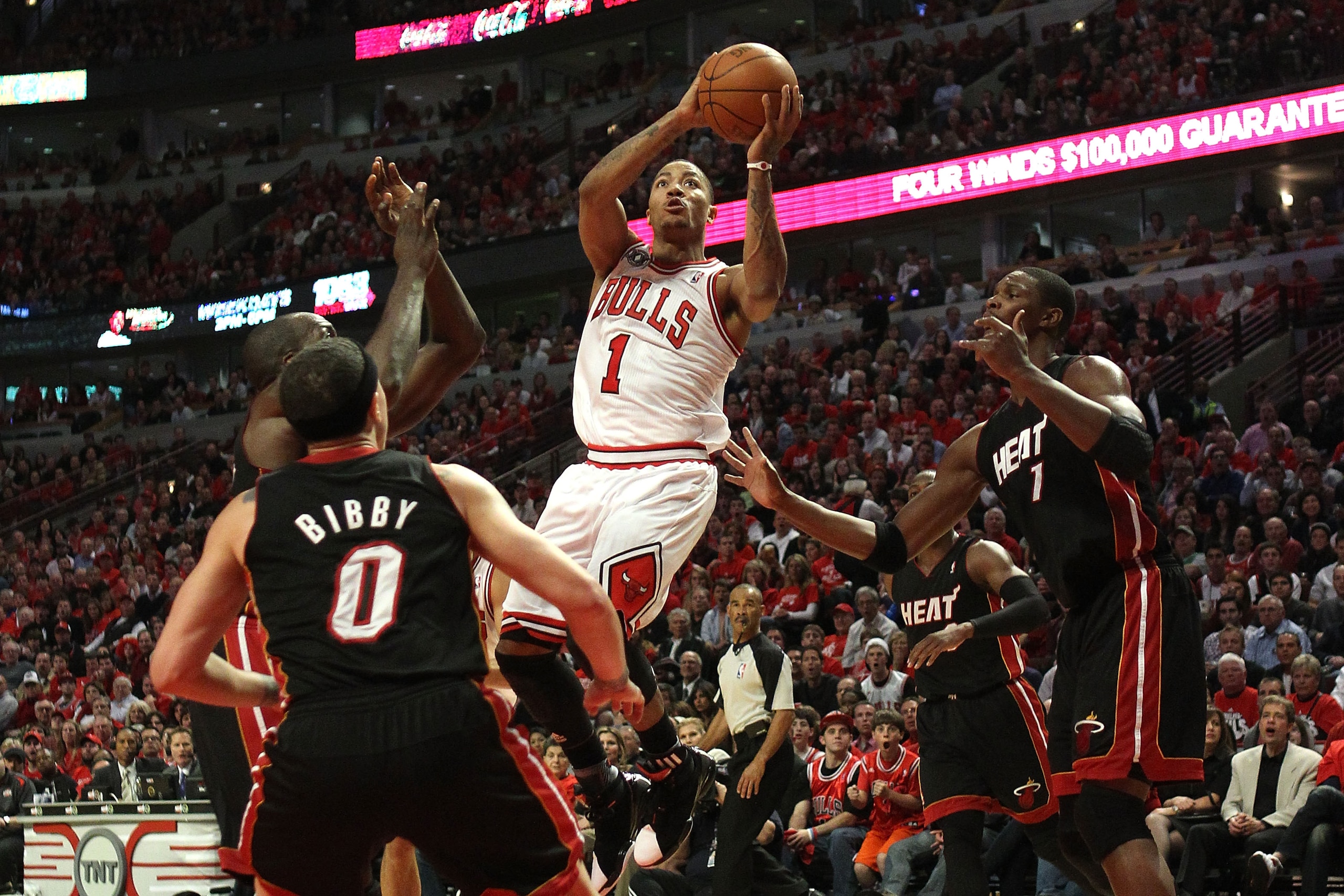 CHICAGO, IL - MAY 15:  Derrick Rose #1 of the Chicago Bulls attempts a shot against Mike Bibby #0, Joel Anthony #50 and Chris Bosh #1 of the Miami Heat in Game One of the Eastern Conference Finals during the 2011 NBA Playoffs on May 15, 2011 at the United