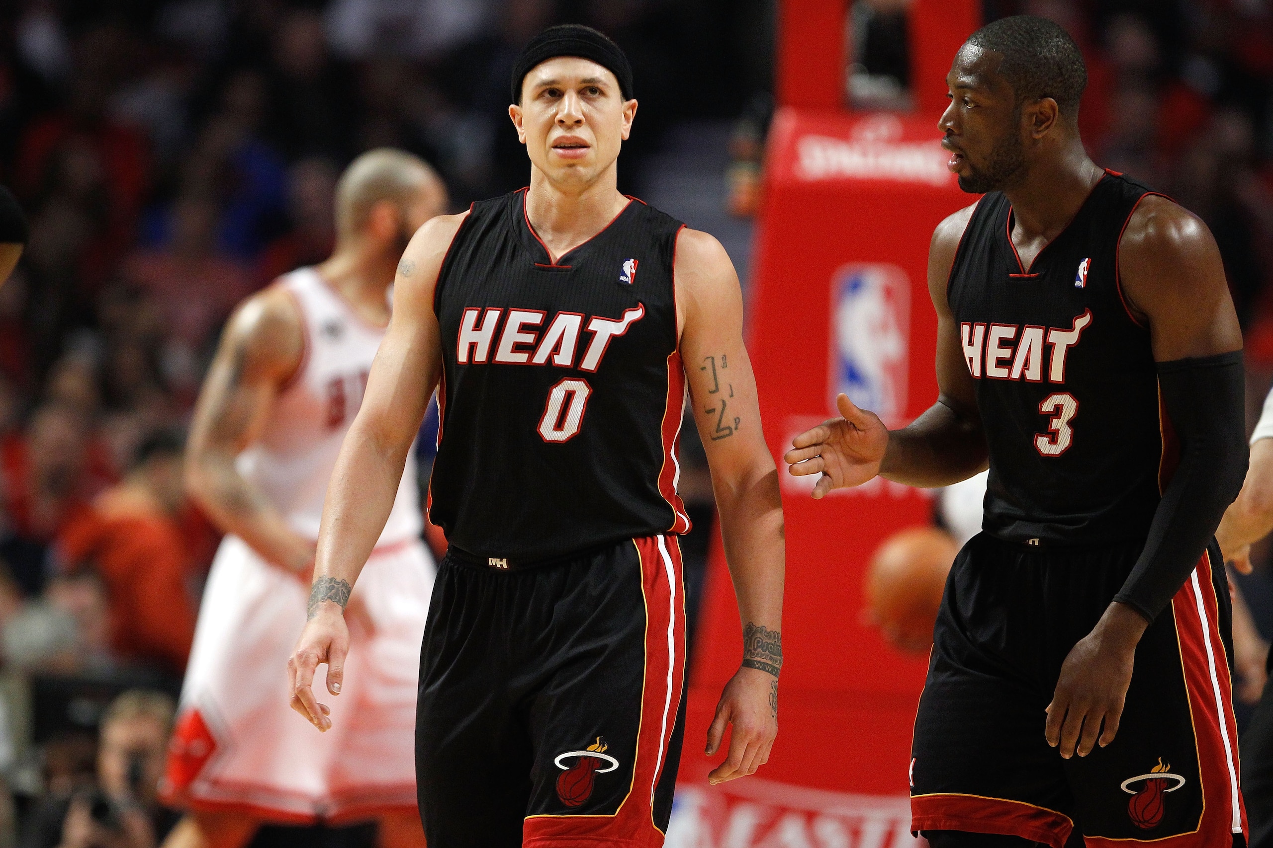 CHICAGO, IL - MAY 15:  (L-R) Mike Bibby #0 and Dwyane Wade #3 of the Miami Heat talk on court in the first quarter against the Chicago Bulls in Game One of the Eastern Conference Finals during the 2011 NBA Playoffs on May 15, 2011 at the United Center in