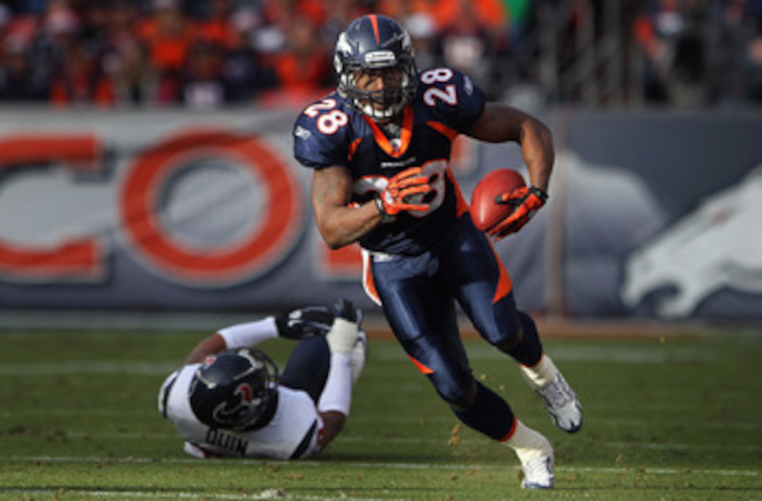 DENVER - DECEMBER 26:  Running back Correll Buckhalter #28 of the Denver Broncos picks up yardage after eluding cornerback Glover Quin #29 of the Houston Texans at INVESCO Field at Mile High on December 26, 2010 in Denver, Colorado. The Broncos defeated t
