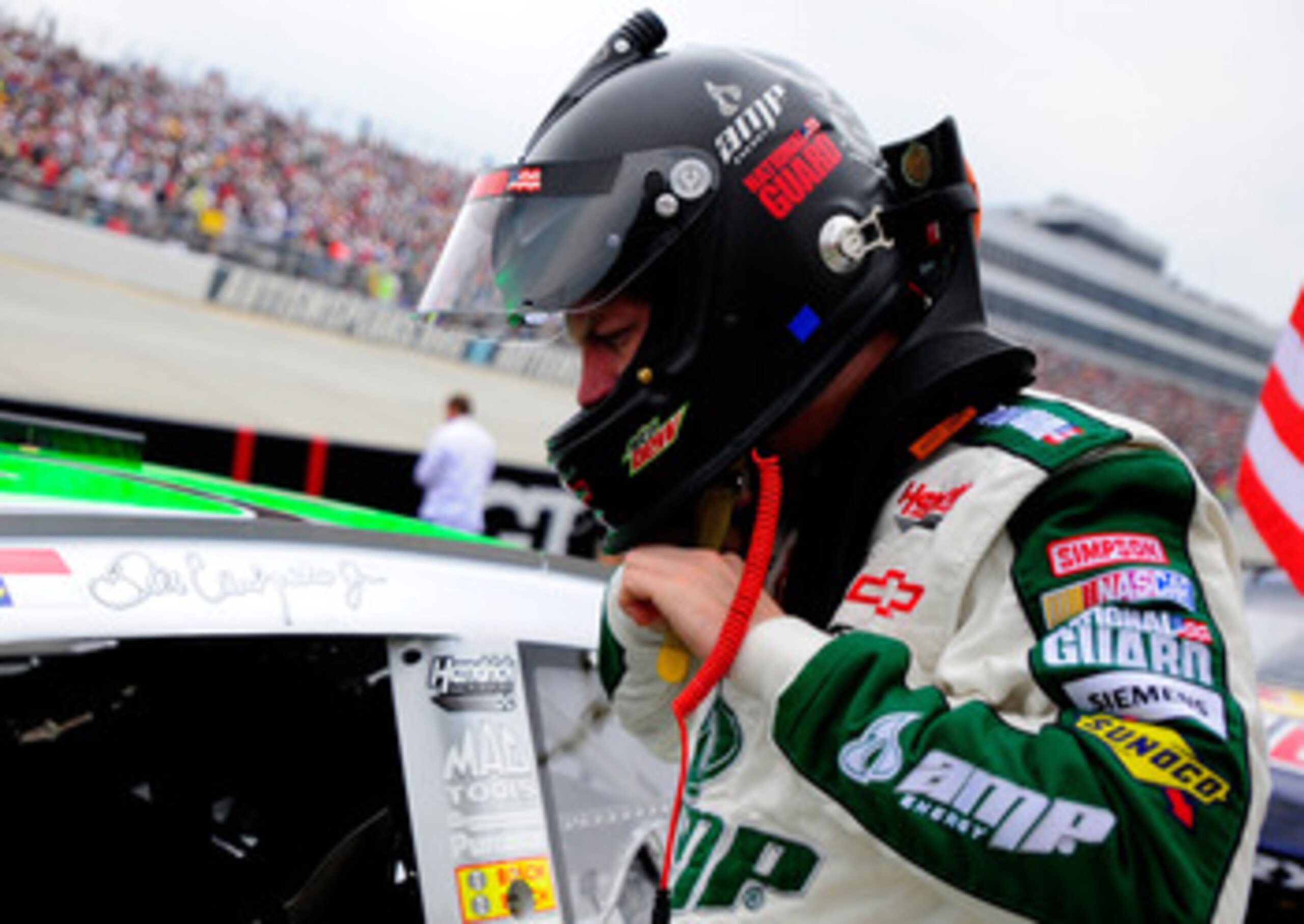 DOVER, DE - MAY 15:  Dale Earnhardt Jr., driver of the #88 Amp Energy Sugar Free/National Guard Chevrolet, stands on the grid prior to the NASCAR Sprint Cup Series FedEx 400 Benefiting Autism Speaks at Dover International Speedway on May 15, 2011 in Dover