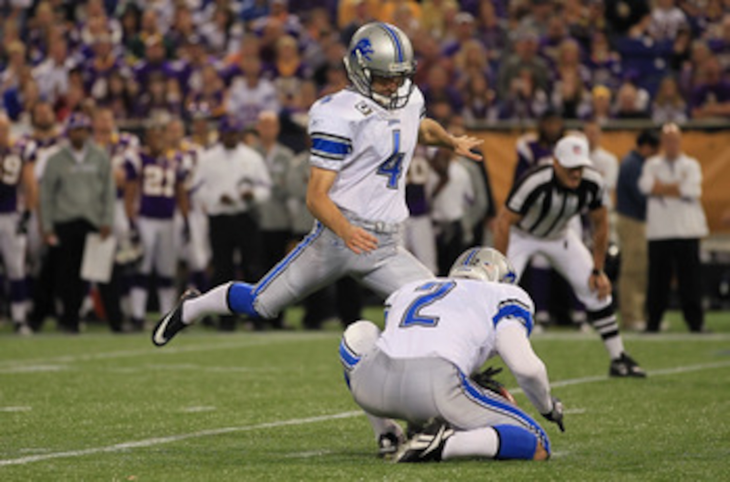 MINNEAPOLIS - SEPTEMBER 26:  Kicker Jason Hanson #4 of the Detroit Lions kicks as place kicker Nick Harris #2 holds against the Minnesota Vikings at Mall of America Field on September 26, 2010 in Minneapolis, Minnesota.  (Photo by Jeff Gross/Getty Images)