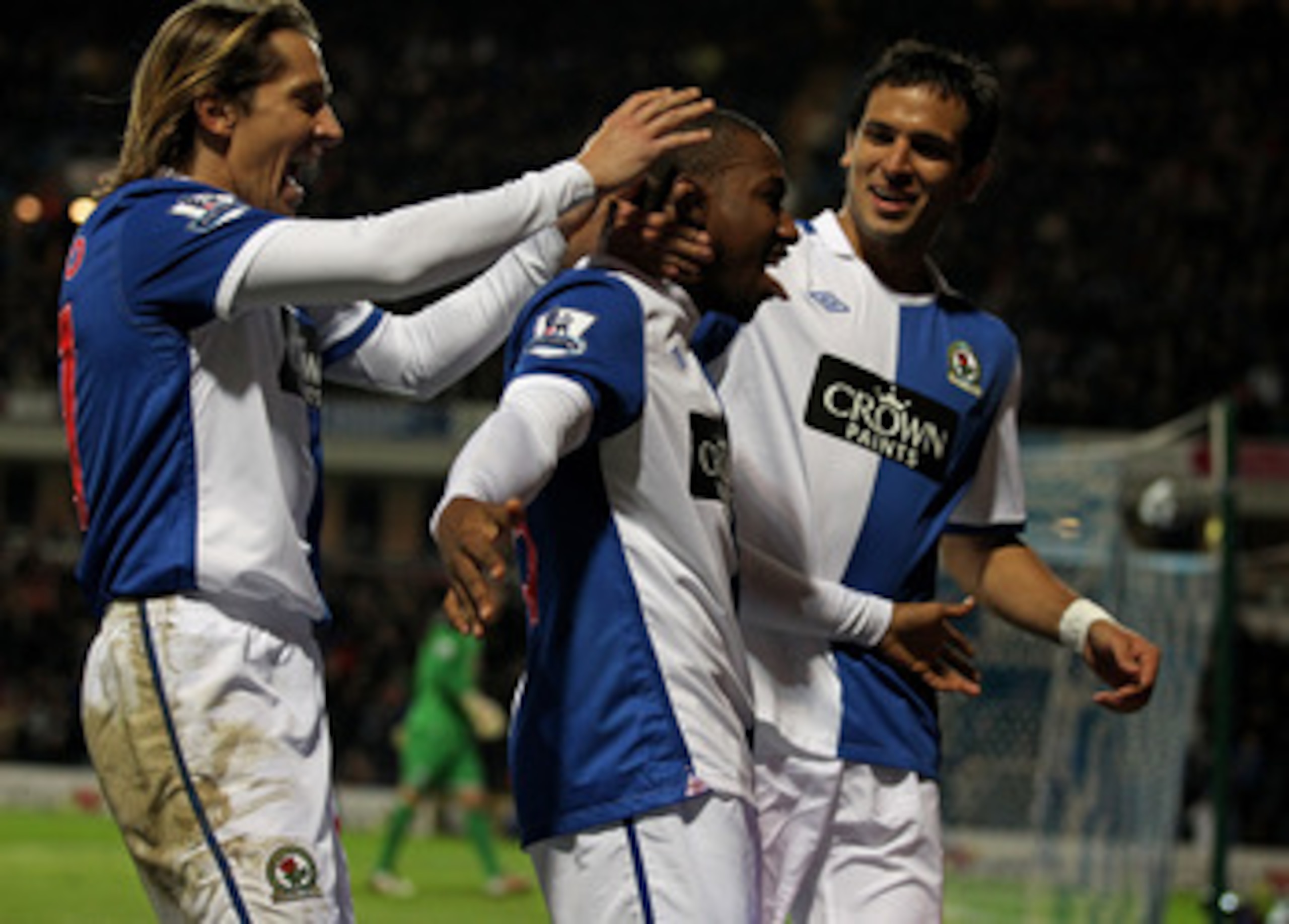 BLACKBURN, ENGLAND - JANUARY 23:  Junior Hoilett of Blackburn Rovers celebrates with his team mates Roque Santa Cruz and Michel Salgado (L) after scoring his team's second goal during the Barclays Premier League match between Blackburn Rovers and West Bro