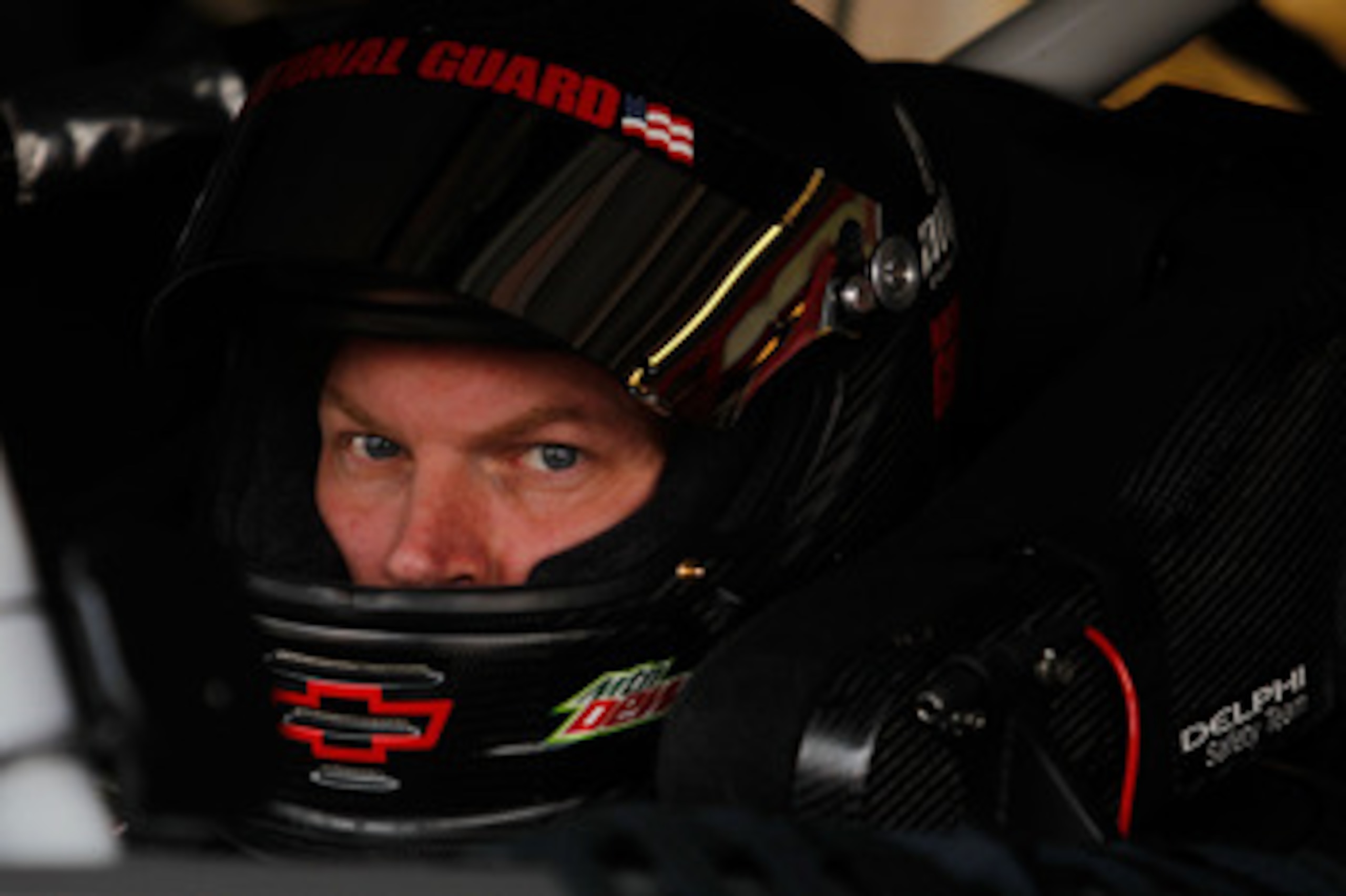 DOVER, DE - MAY 13:  Dale Earnhardt Jr., driver of the #88 Amp Energy Sugar Free/National Guard Chevrolet, sits in his car during practice for the NASCAR Sprint Cup Series FedEx 400 Benefiting Autism Speaks at Dover International Speedway on May 13, 2011