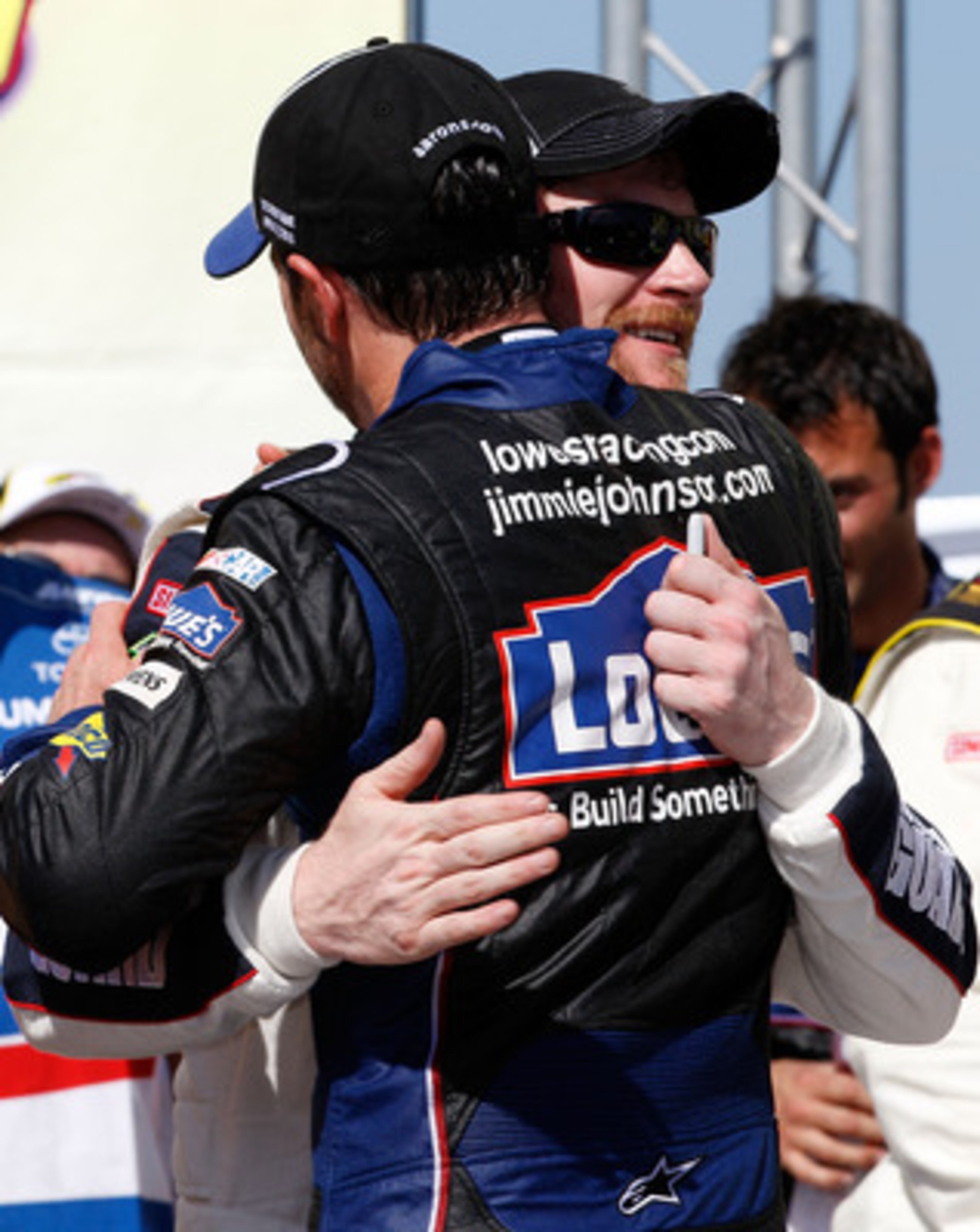 TALLADEGA, AL - APRIL 17: Jimmie Johnson (FRONT), driver of the #48 Lowe's Chevrolet, hugs teammates Dale Earnhardt Jr. (BACK), driver of the #88 National Guard/Amp Energy Chevrolet, in Victory Lane after winning the NASCAR Sprint Cup Series Aaron's 499 TALLADEGA, AL - APRIL 17: Jimmie Johnson (FRONT), driver of the #48 Lowe's Chevrolet, hugs teammates Dale Earnhardt Jr. (BACK), driver of the #88 National Guard/Amp Energy Chevrolet, in Victory Lane after winning the NASCAR Sprint Cup Series Aaron's 499