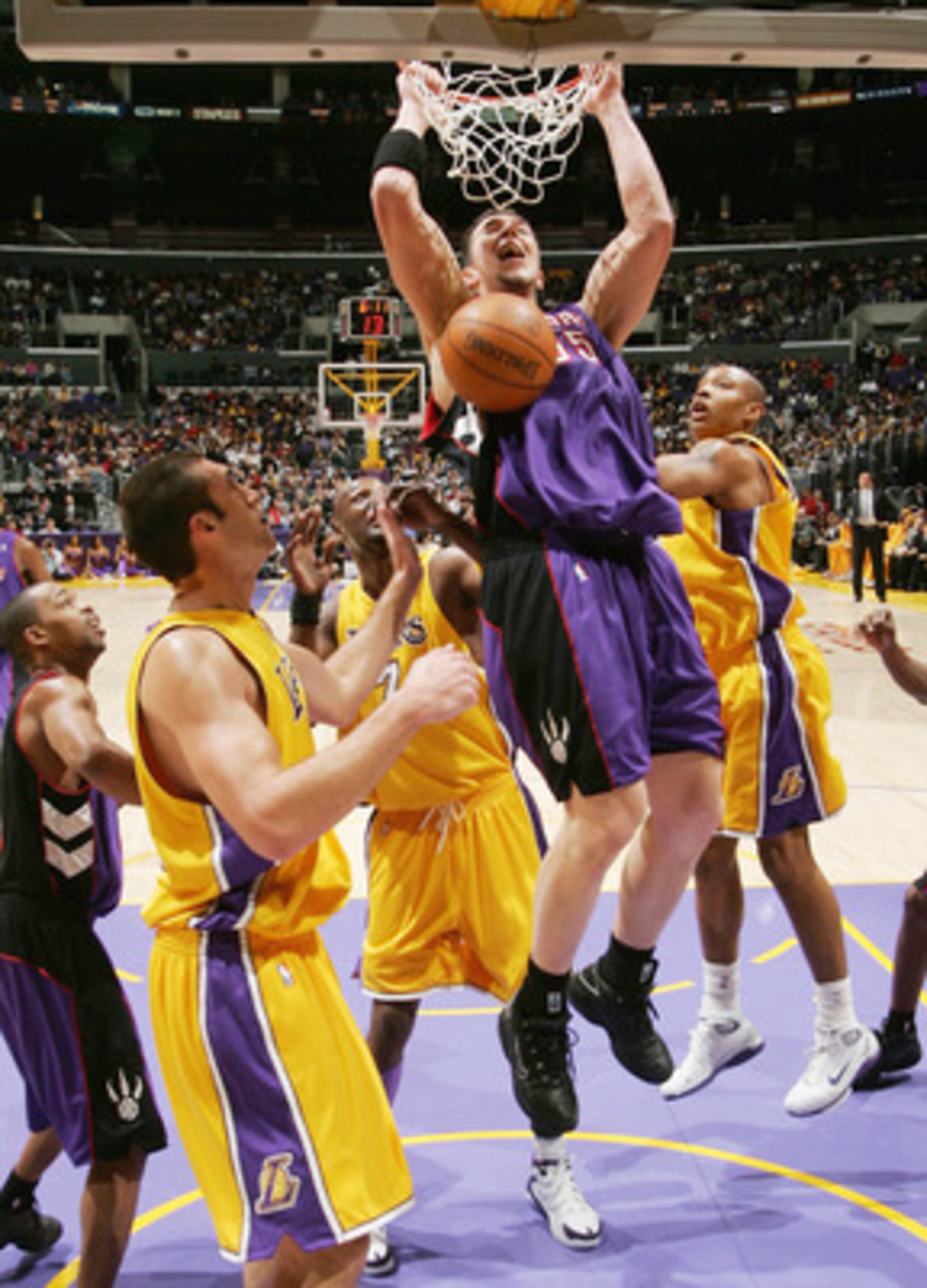 LOS ANGELES - DECEMBER 28:  Rafael Araujo #55 of the Toronto Raptors slams over Chris Mihm #31 of the Los Angeles Lakers on December 28, 2004 at Staples Center in Los Angeles, California. The Lakers won 117-99.  NOTE TO USER: User expressly acknowledges a