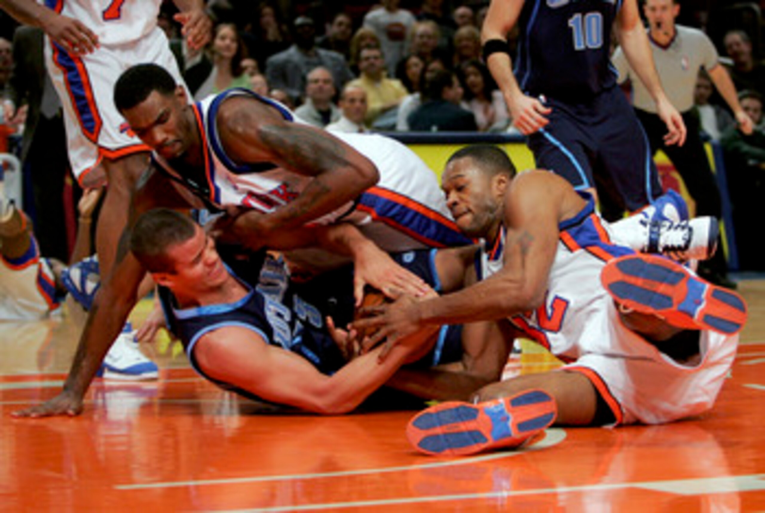NEW YORK - DECEMBER 23:  Qyntel Woods #6 and Antonio Davis #32 of the New York Knicks fight for the ball with Kris Humphries #43 of the Utah Jazz on December 23, 2005 at Madison Square Garden in New York City. The Knicks won 98-90. NOTE TO USER: User expr