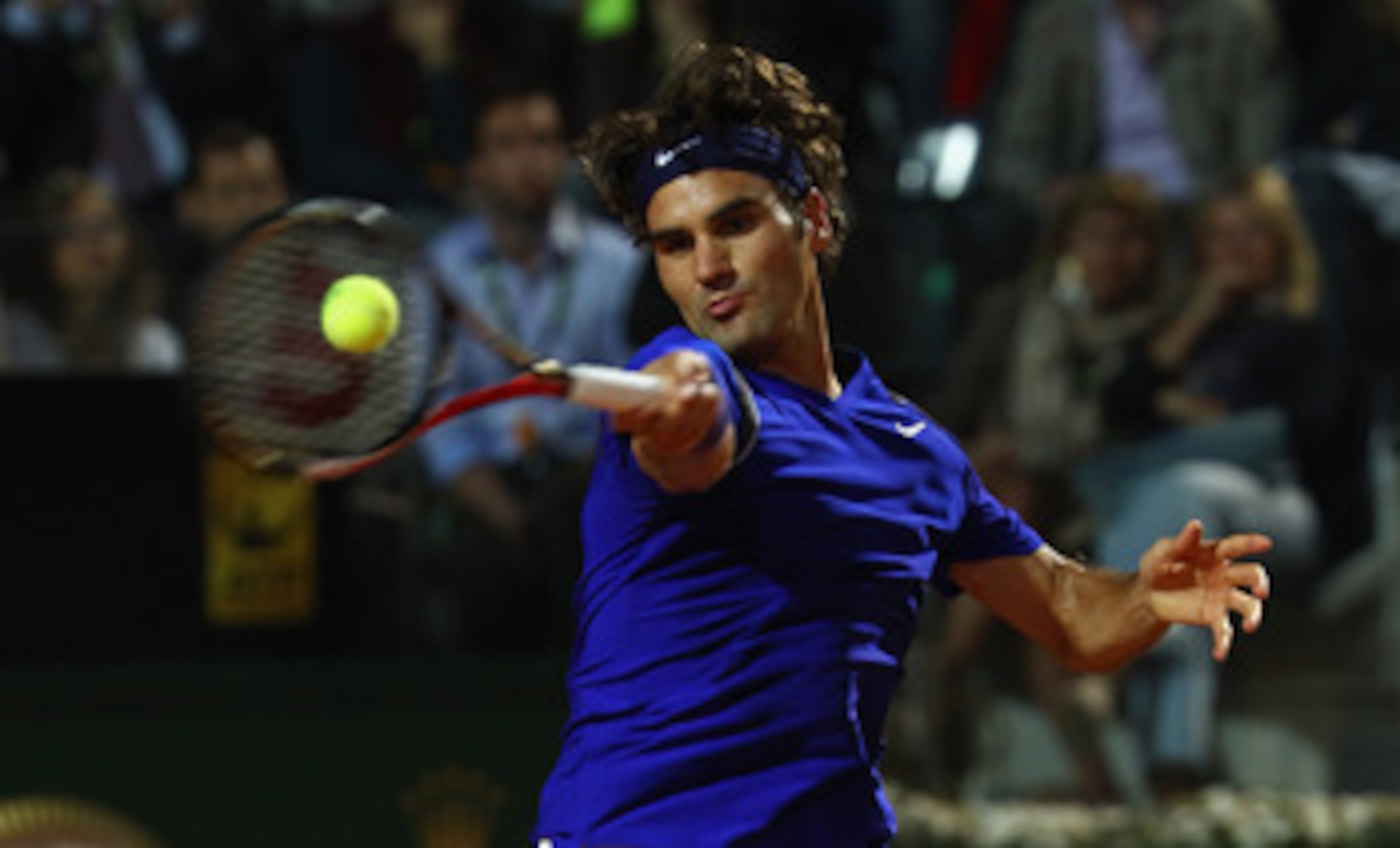 ROME, ITALY - MAY 11:  Roger Federer of Switzerland plays a forehand during his second round match against Jo-Wilfried Tsonga of France during day four of the Internazoinali BNL D'Italia at the Foro Italico Tennis Centre on May 11, 2011 in Rome, Italy.  (