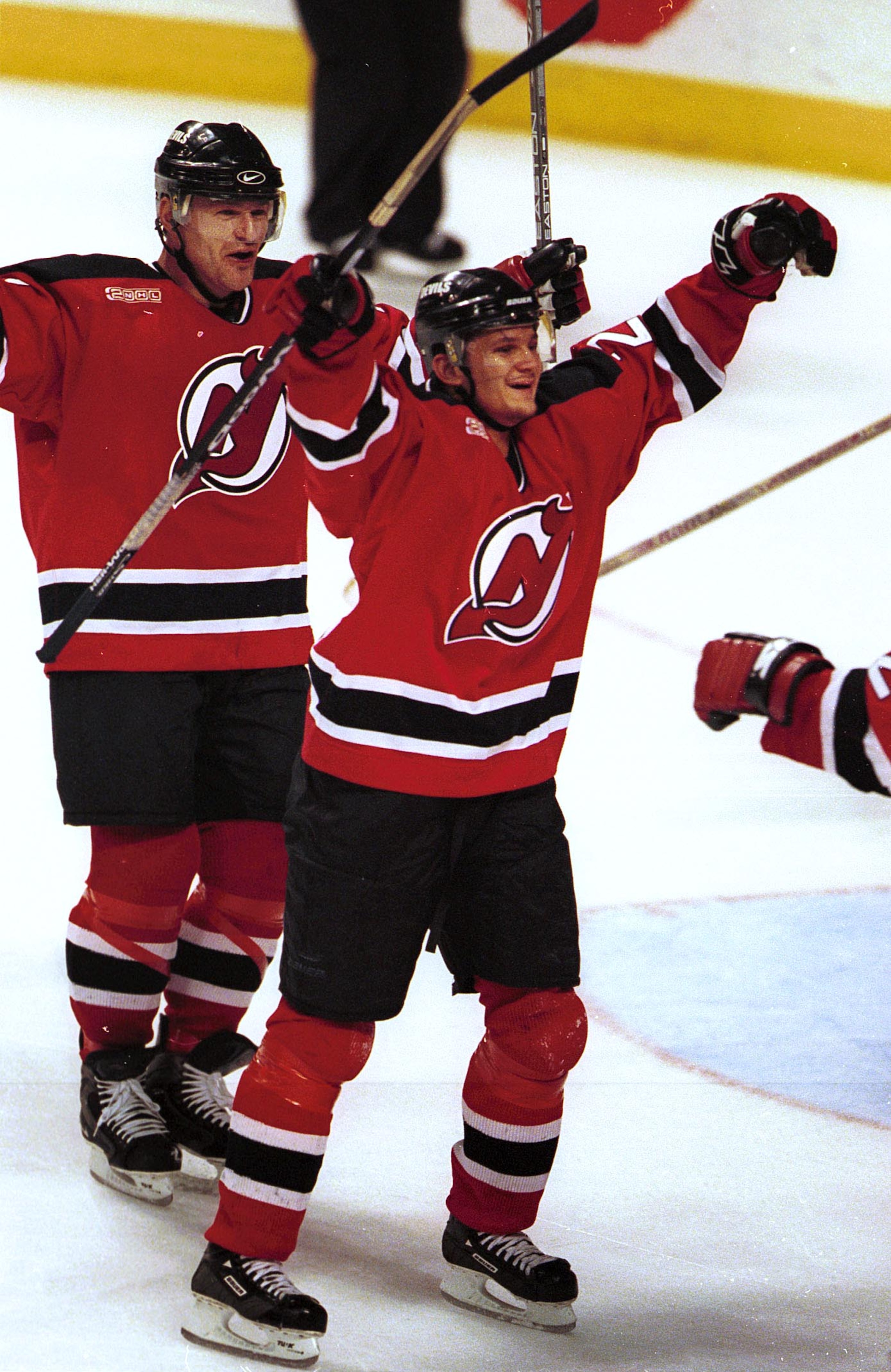 20 Apr 2000:  Left winger Patrik Elias #26 and right winger Claude Lemieux #22 of the New Jersey Devils celebrate a score by teammate Sergei Nemchinov in the third period against the Florida Panthers during the NHL Playoffs at the National Car Rental Cent