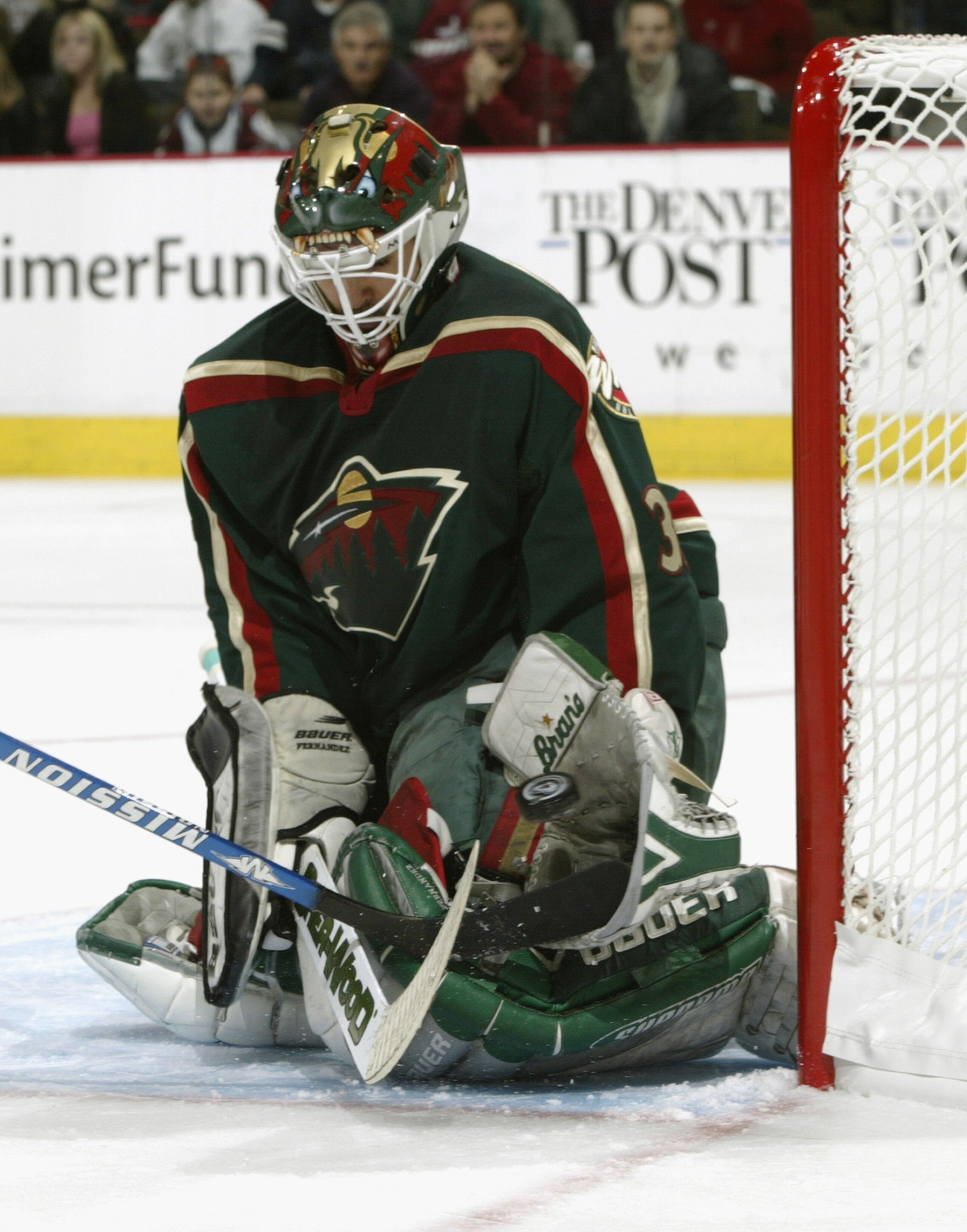 DENVER - APRIL 19:  Goalie Manny Fernandez #35 of the Minnesota Wild stops a shot against the Colorado Avalanche during game five of the first round of the 2003 Western Conference Stanley Cup playoffs on April 19, 2003 at the Pepsi Center in Denver, Color