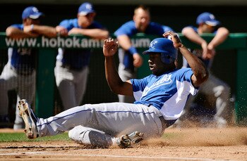 MESA, AZ - MARCH 09:  Lorenzo Cain #6 of the Kansas City Royals slides into home plate to score against the Chicago Cubs during the spring training baseball game at HoHoKam Stadium on March 9, 2011 in Mesa, Arizona.  (Photo by Kevork Djansezian/Getty Imag