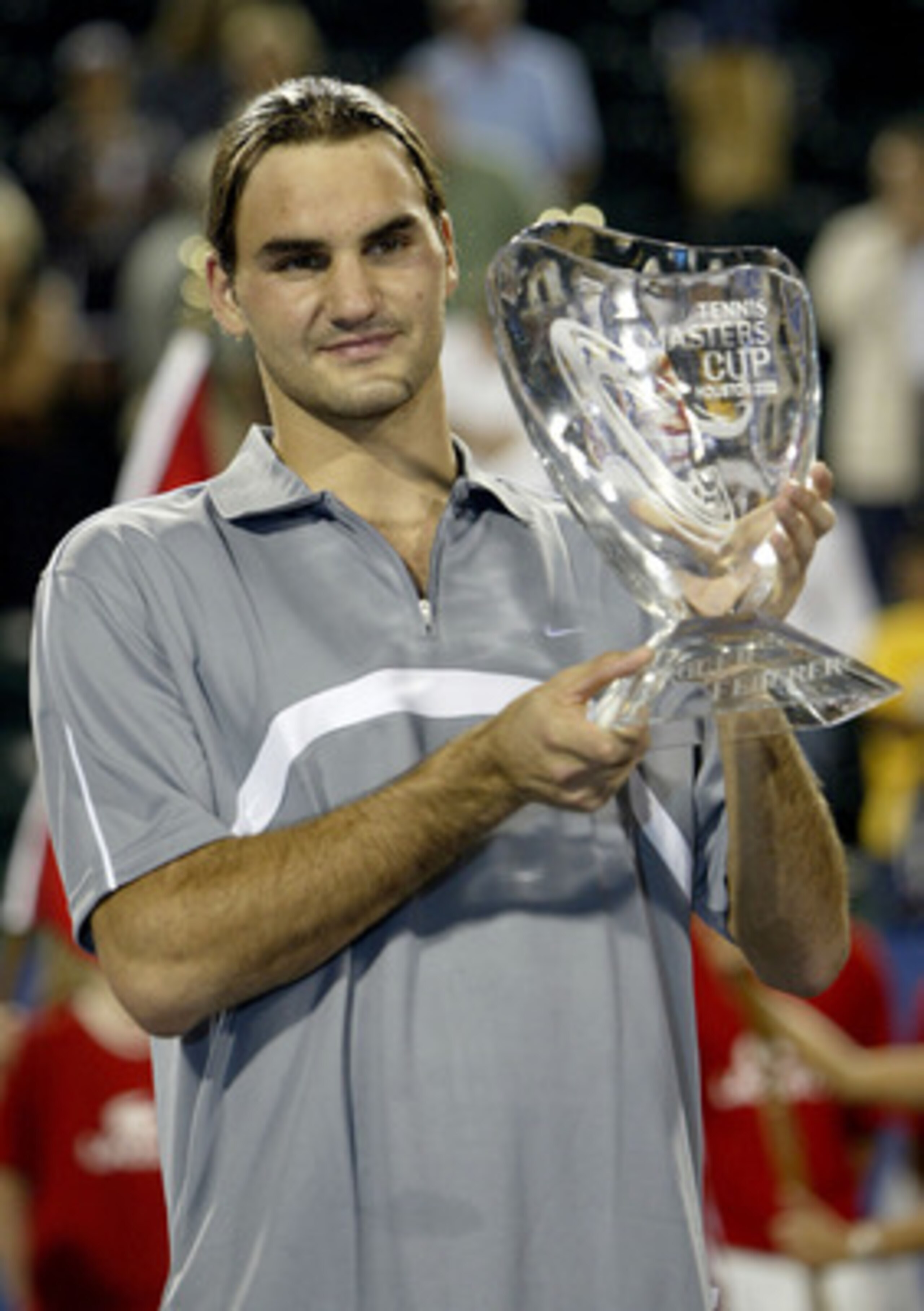 HOUSTON - NOVEMBER 16:  Roger Federer of Switzerland poses for photographers after his victory over Andre Agassi during the finals of the Tennis Masters Cup November 16, 2003 at the Westside Tennis Club in Houston, Texas. (Photo by Clive Brunskill/Getty I