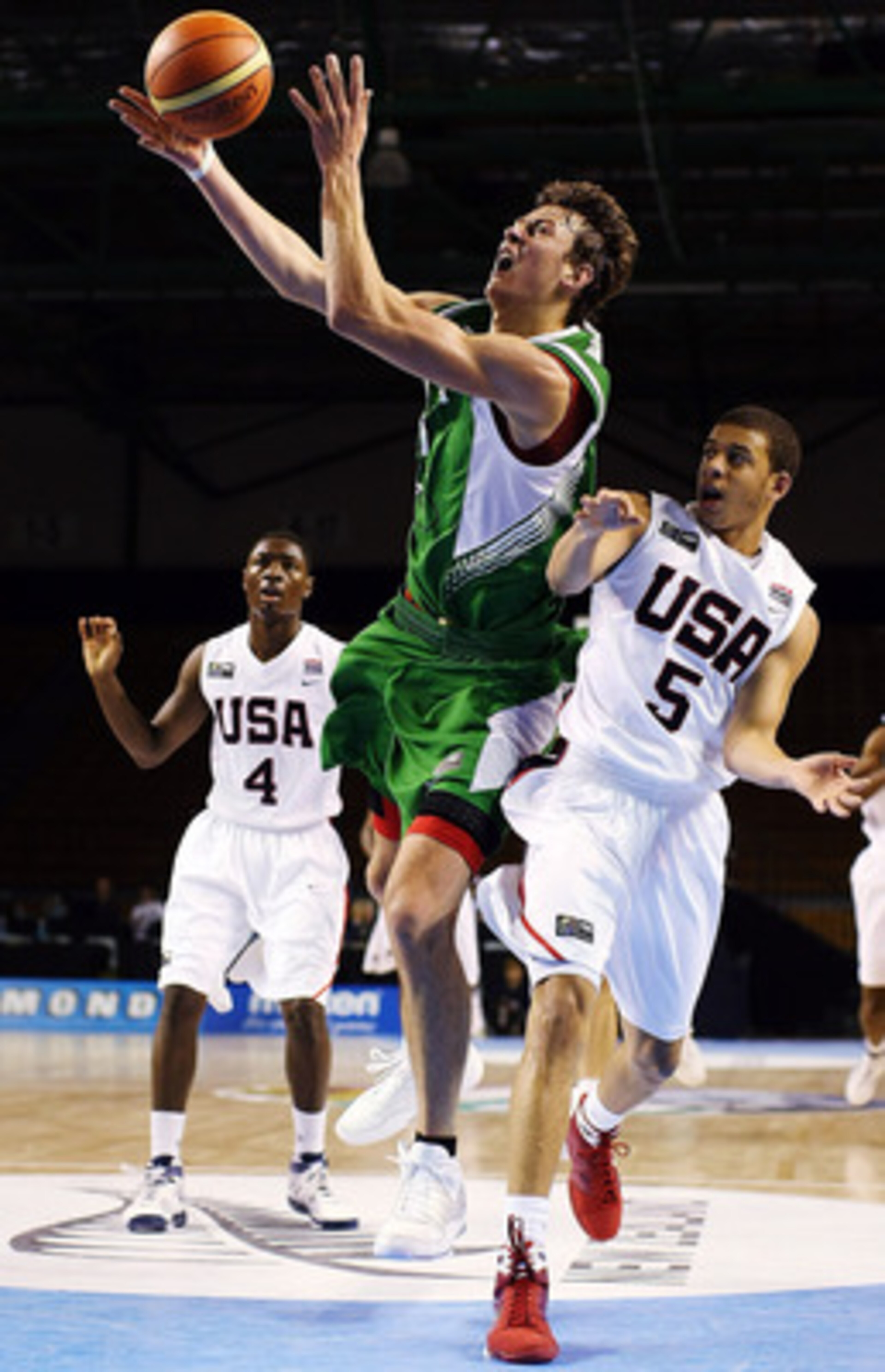 AUCKLAND, NEW ZEALAND - JULY 08:  Donatas Motiejunas of Lithuania takes the ball to the hoop as Seth Curry of the United States defends during the U19 Basketball World Championships match between the United States and Lithuania at North Shore Events Centr