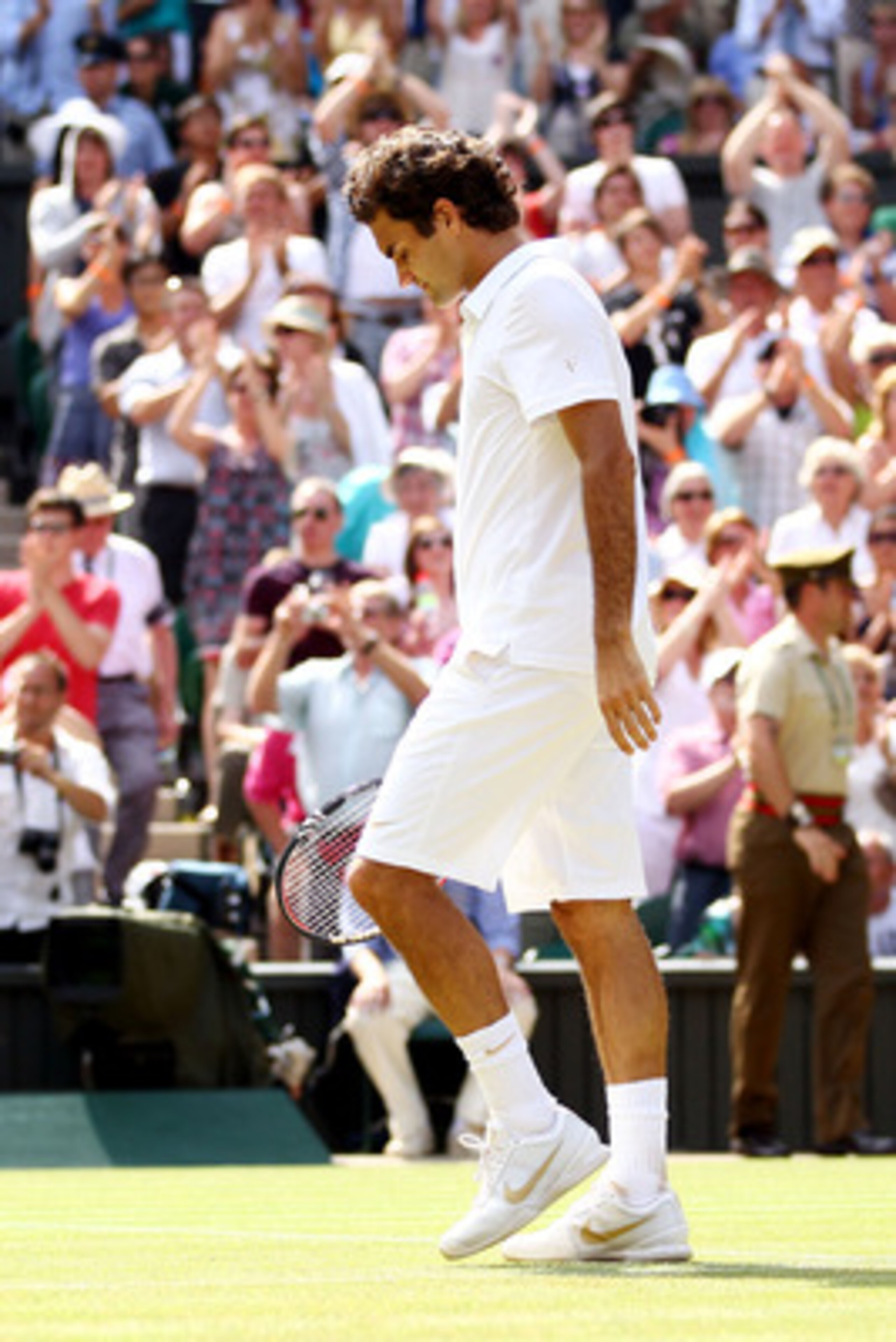 LONDON, ENGLAND - JUNE 30:  Roger Federer of Switzerland waves as he exits after losing his Quarter Final match against Tomas Berdych of Czech Republic on Day Nine of the Wimbledon Lawn Tennis Championships at the All England Lawn Tennis and Croquet Club