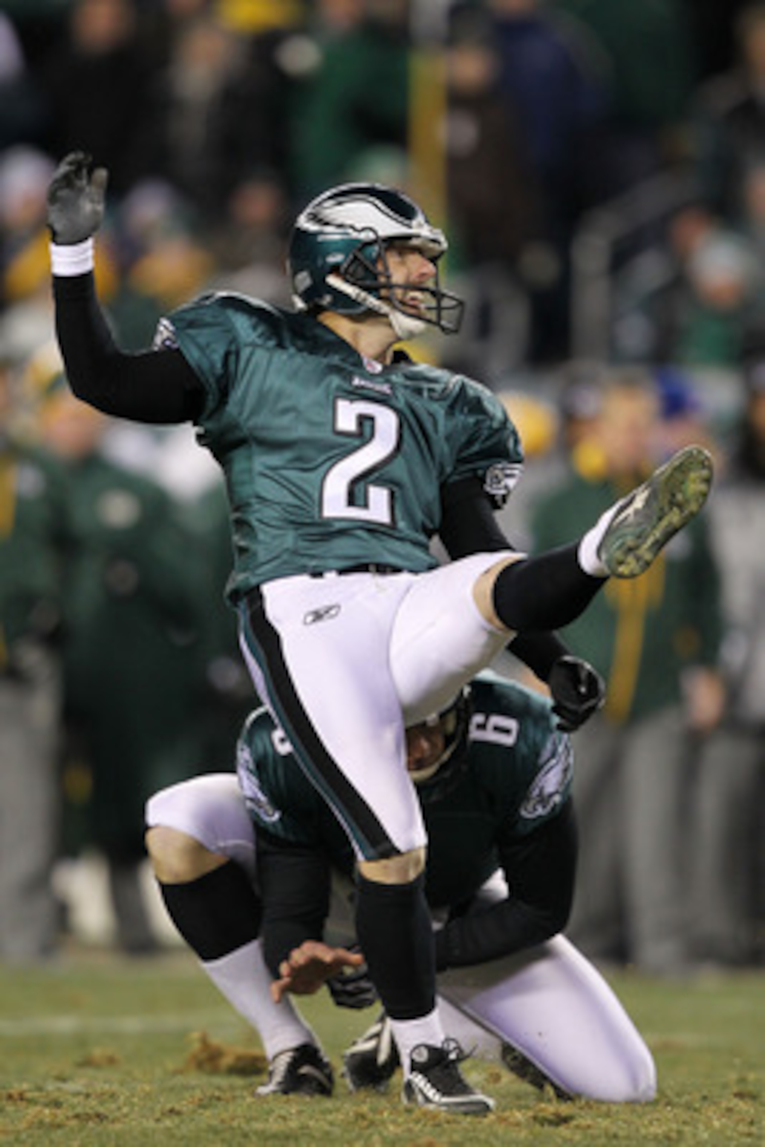 PHILADELPHIA, PA - JANUARY 09:  David Akers #2 kicks as Sav Rocca #6 of the Philadelphia Eagles holds against the Green Bay Packers during the 2011 NFC wild card playoff game at Lincoln Financial Field on January 9, 2011 in Philadelphia, Pennsylvania.  (P