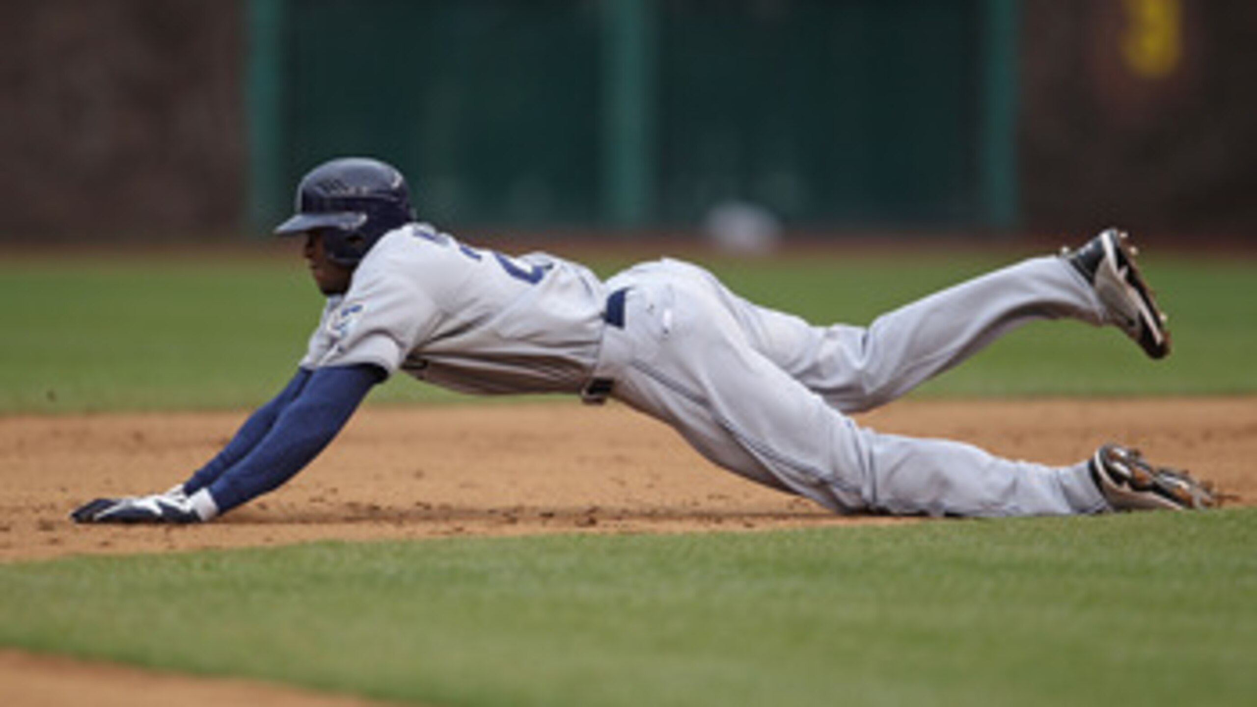 CHICAGO, IL - APRIL 20: Cameron Maybin #24 of the San Diego Padres dives into 2nd base against the Chicago Cubs at Wrigley Field on April 20, 2011 in Chicago, Illinois. The Cubs defeated the Padres 2-1 in 11 innings. (Photo by Jonathan Daniel/Getty Images