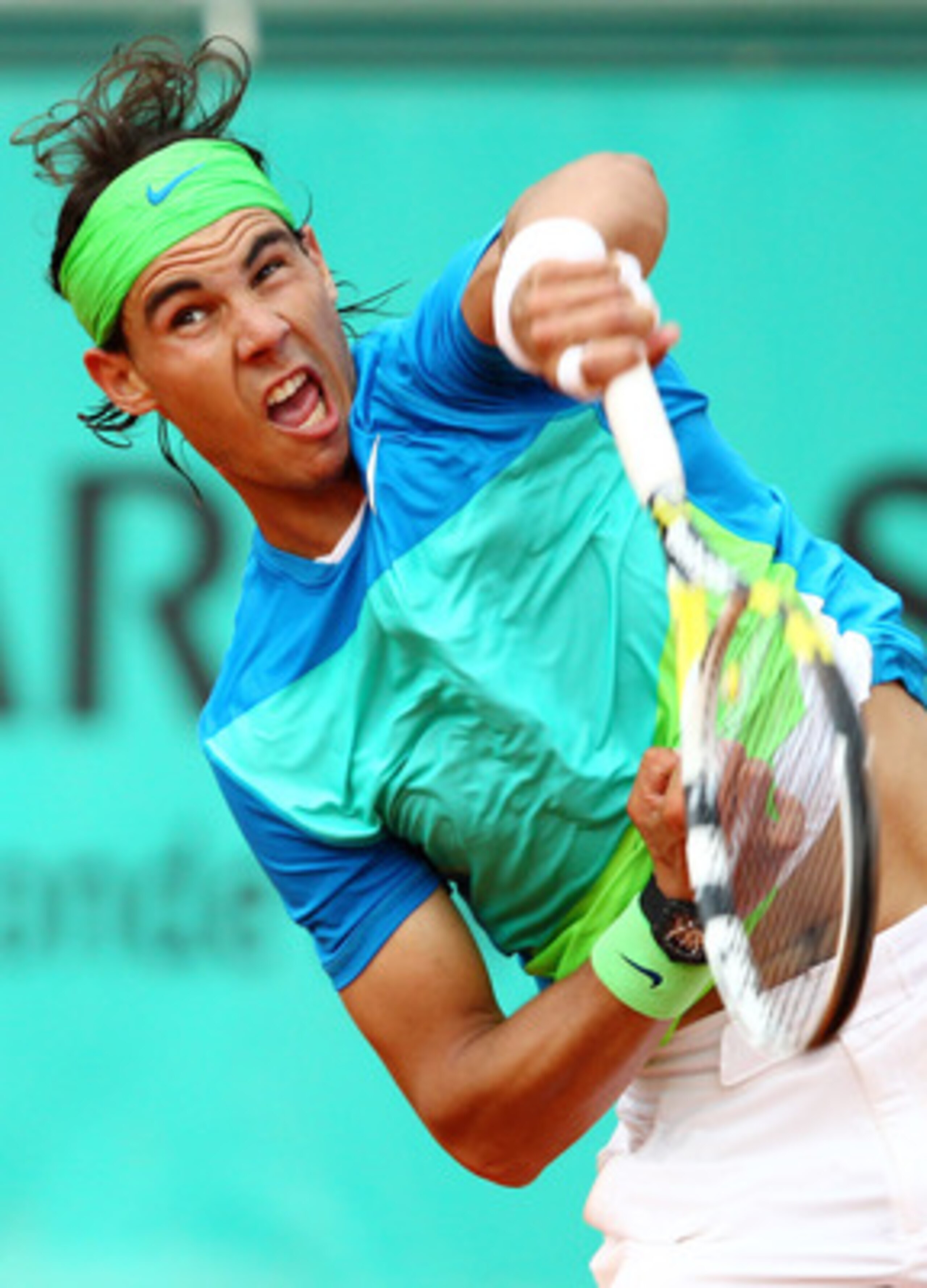 PARIS - MAY 25:  Rafael Nadal of Spain serves during the men's singles first round match between Rafael Nadal of Spain and Gianni Mina of France on day three of the French Open at Roland Garros on May 25, 2010 in Paris, France.  (Photo by Clive Brunskill/
