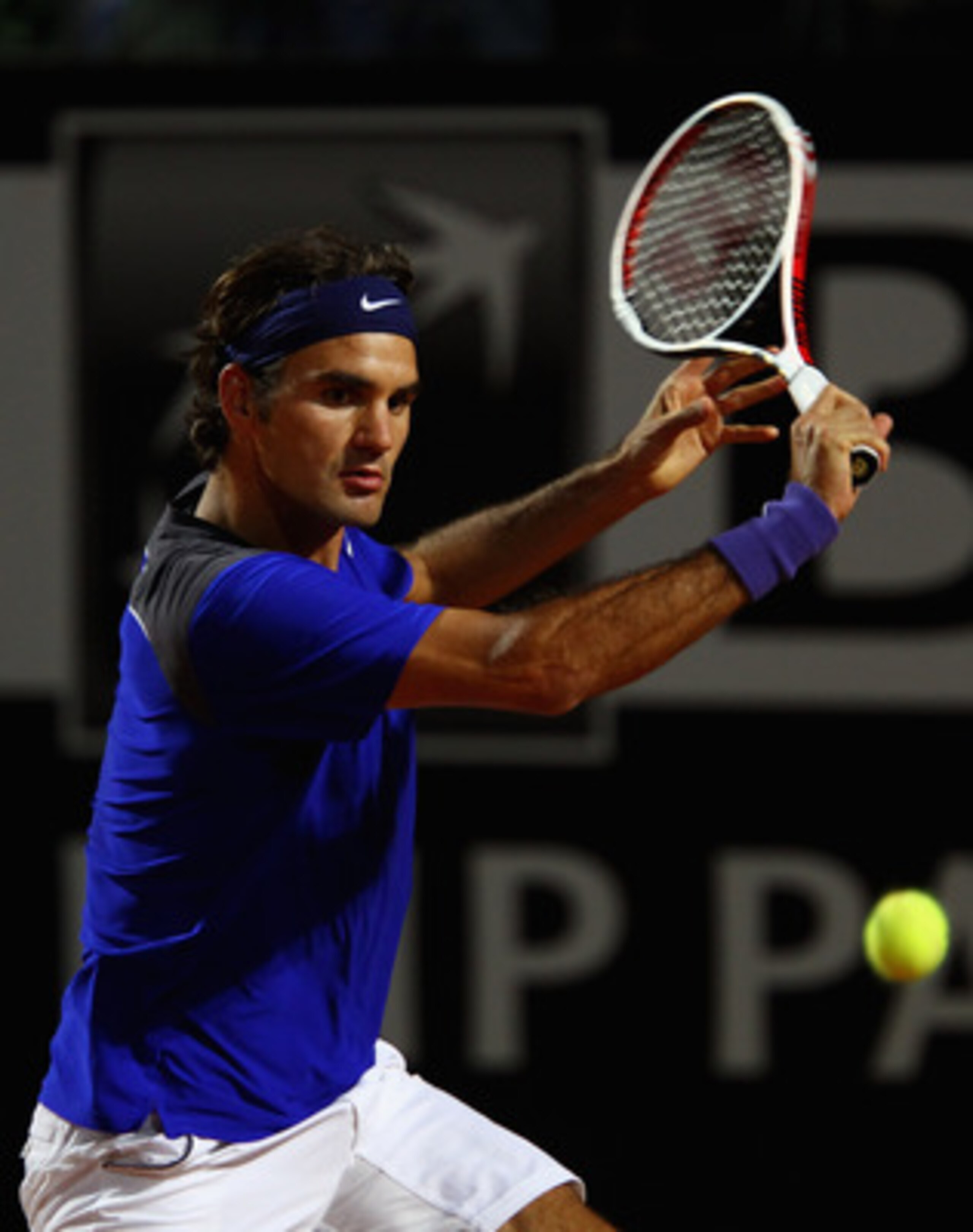 ROME, ITALY - MAY 11:  Roger Federer of Switzerland plays a backhand during his second round match against Jo-Wilfried Tsonga of France during day four of the Internazoinali BNL D'Italia at the Foro Italico Tennis Centre on May 11, 2011 in Rome, Italy.  (