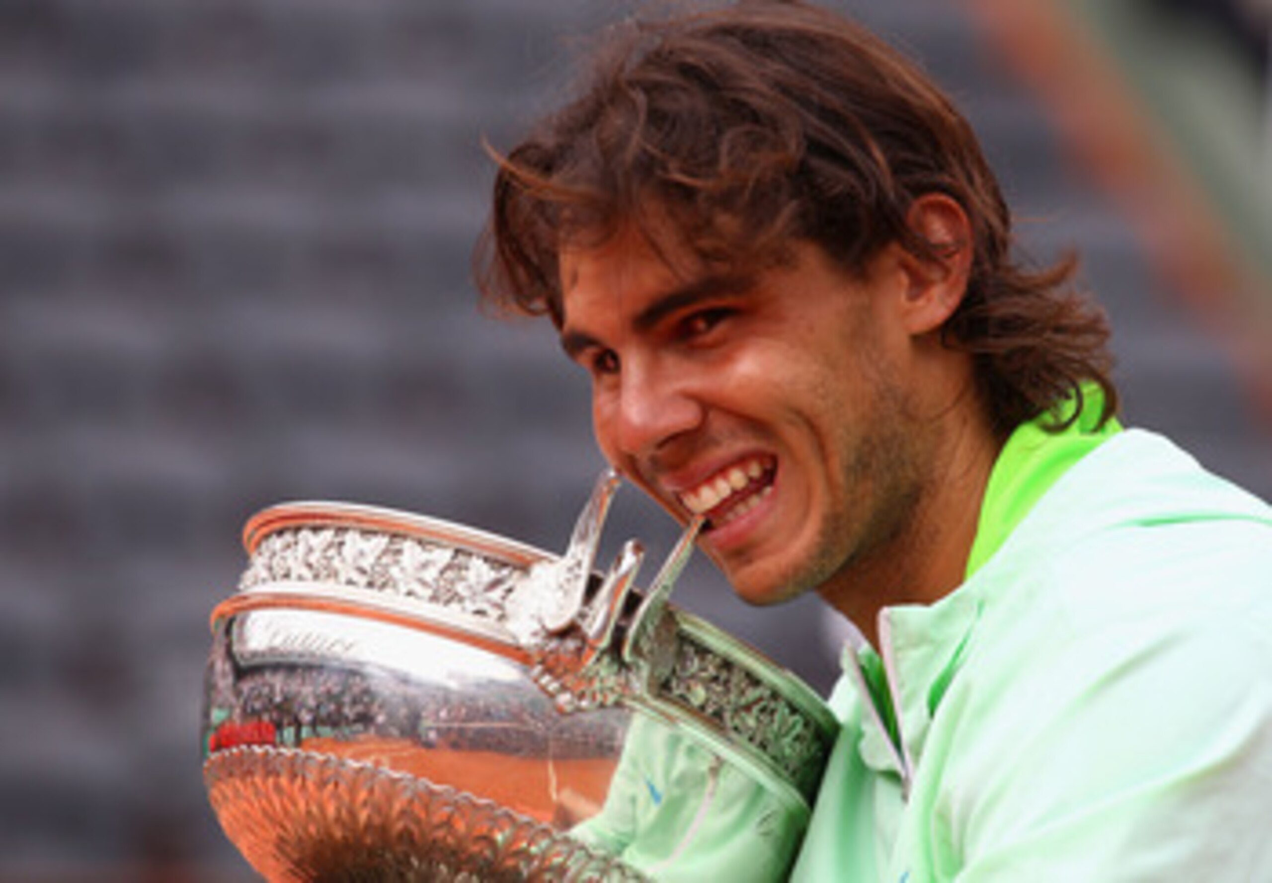 PARIS - JUNE 06:  Rafael Nadal of Spain celebrates with the trophy after winning the men's singles final match between Rafael Nadal of Spain and Robin Soderling of Sweden on day fifteen of the French Open at Roland Garros on June 6, 2010 in Paris, France.