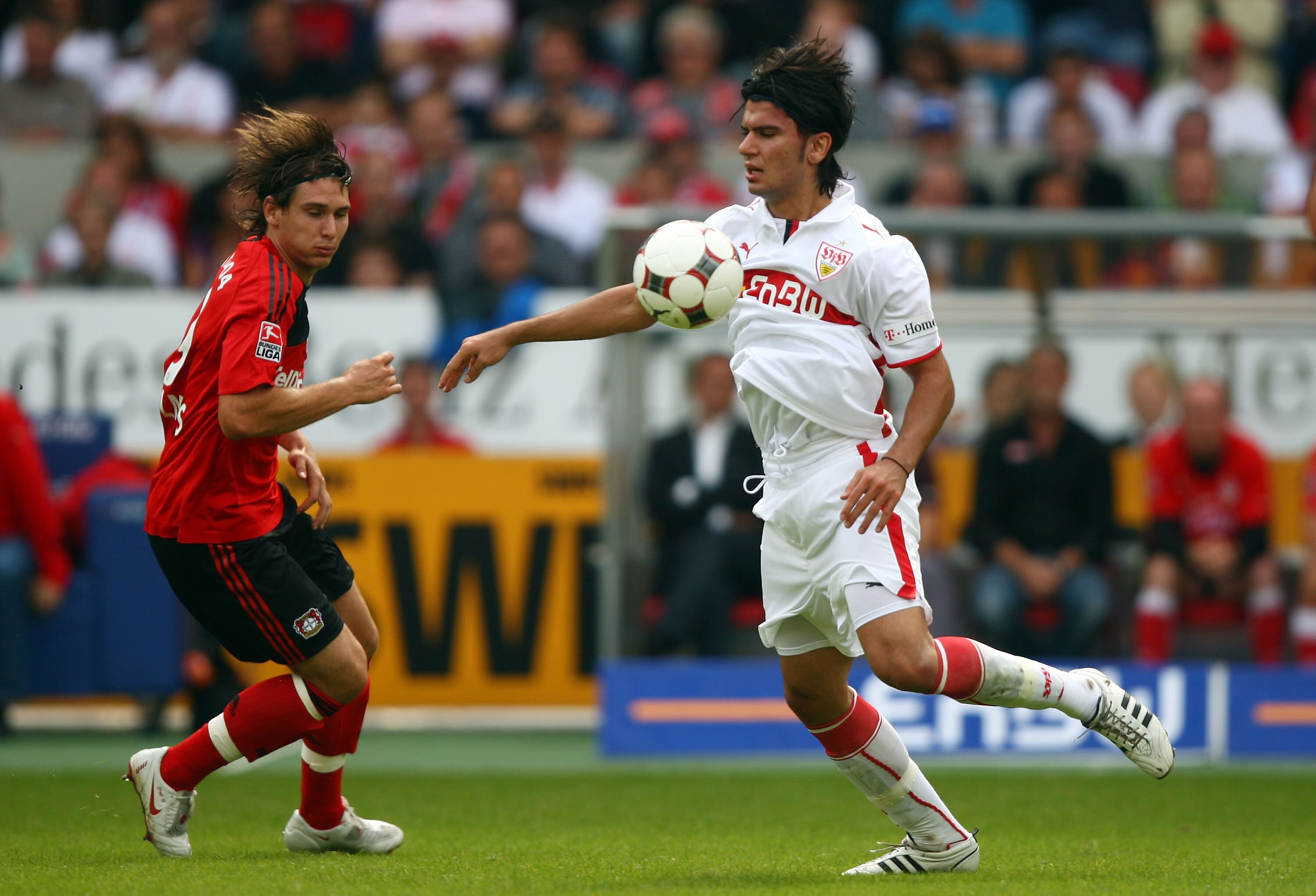 STUTTGART, GERMANY - AUGUST 23:  Serdar Tasci (R) of Stuttgart in action with Patrick Helmes of Leverkusen during the Bundesliga match between VfB Stuttgart and Bayer Leverkusen at the Mercedes-Benz Arena on August 23, 2008 in Stuttgart, Germany.  (Photo