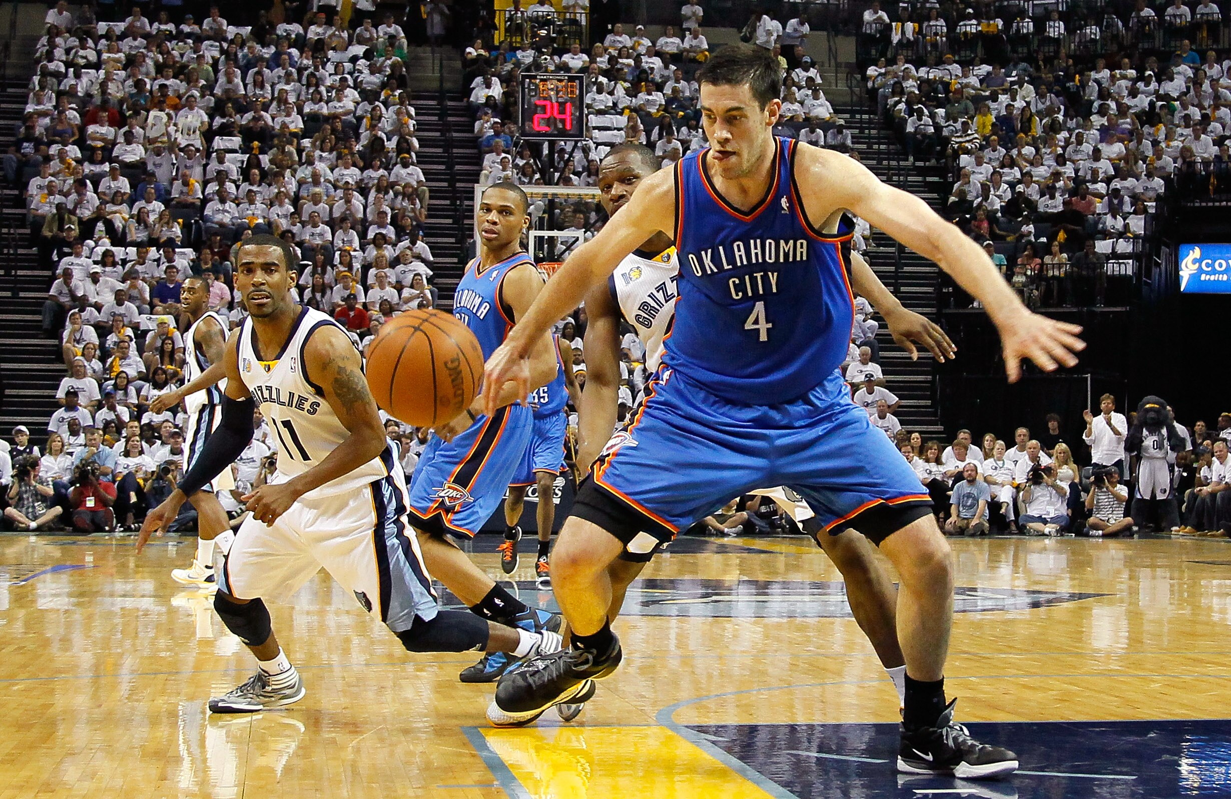 MEMPHIS, TN - MAY 13:  Russell Westbrook #0 watches ass Nick Collison #4 of the Oklahoma City Thunder grabs a loose ball against Mike Conley #11 and Sam Young #4 of the Memphis Grizzlies in Game Six of the Western Conference Semifinals in the 2011 NBA Pla