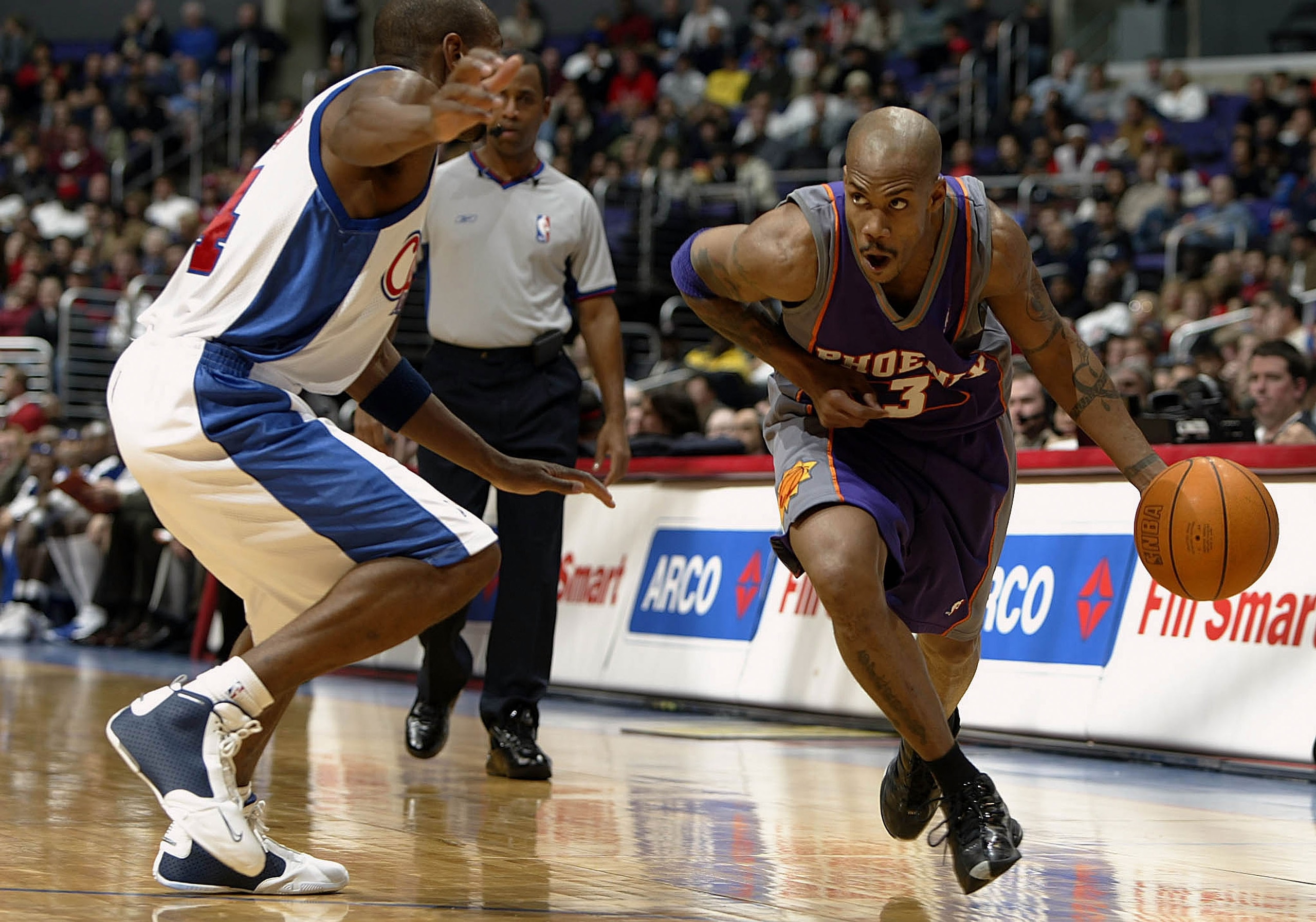 LOS ANGELES - DECEMBER 29:  Stephon Marbury #3 of the Phoenix Suns drives past Doug Overton #24 of the Los Angeles Clippers during their game on December 29, 2003 at Staples Center in Los Angeles, California. The Suns won 113-105.  NOTE TO USER: User expr