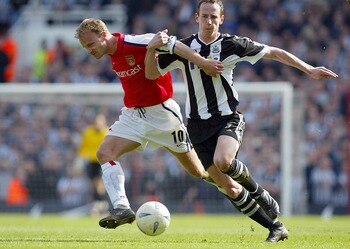 23 Mar 2002:  Dennis Bergkamp of Arsenal is tackled by Andrew O''Brien of Newcastle during the AXA sponsored FA Cup 6th round replay between Arsenal and Newcastle United at Highbury, London. DIGITAL IMAGE. Mandatory Credit: Ben Radford/Getty Images