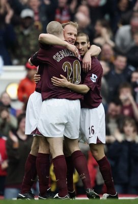 LONDON - APRIL 15:  Dennis Bergkamp of Arsenal celebrates his goal with team mates Philippe Senderos and Mathieu Flamini during the Barclays Premiership match between Arsenal and West Bromwich Albion at Highbury on April 15, 2006 in London, England.  (Pho