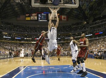DALLAS - JUNE 20:  Dirk Nowitzki #41 of the Dallas Mavericks slam dunks over Gary Payton #20 of the Miami Heat in game six of the 2006 NBA Finals on June 20, 2006 at American Airlines Center in Dallas, Texas.  The Heat won 95-92 and win the series 4-2.  N