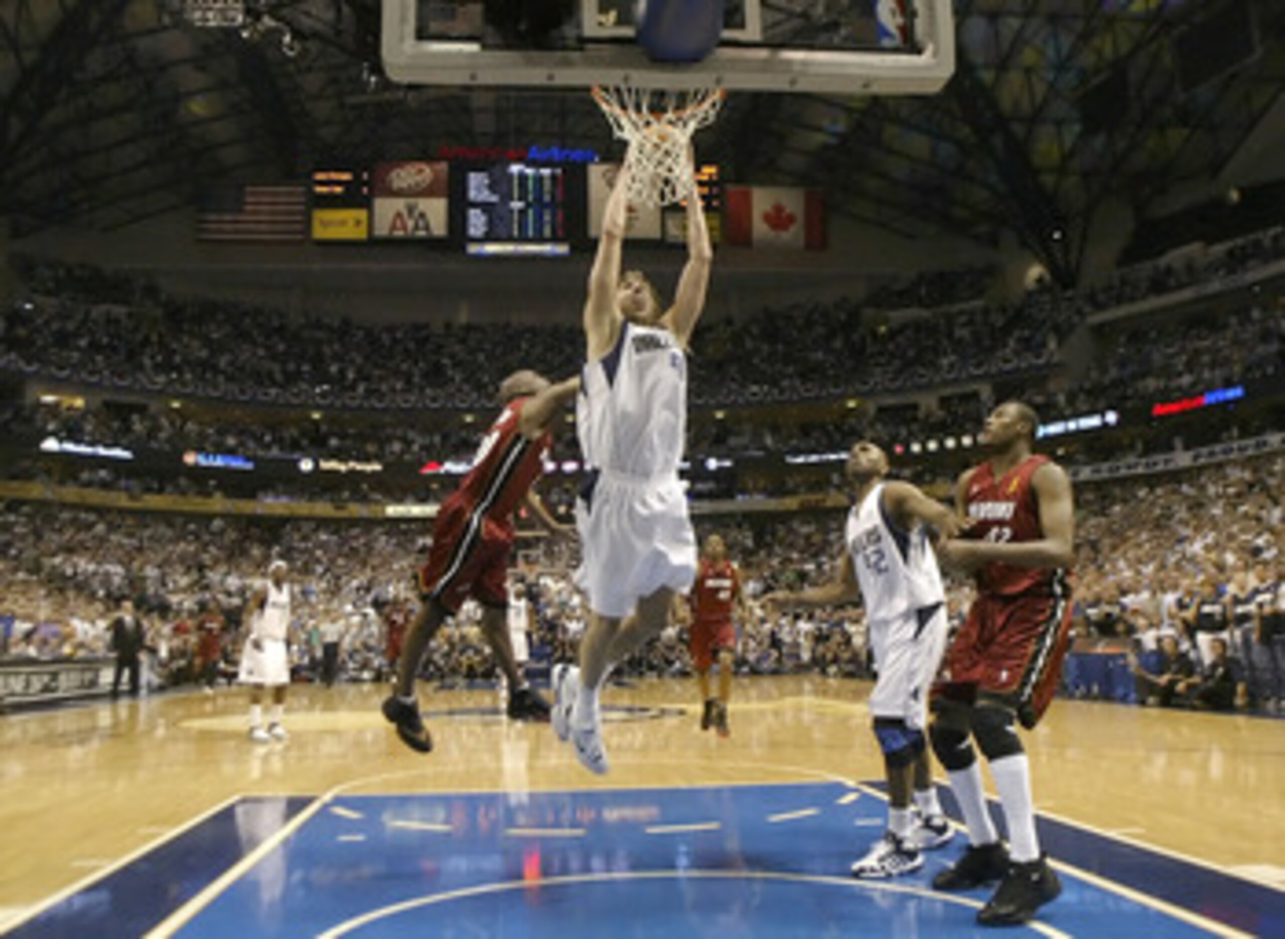 DALLAS - JUNE 20: Dirk Nowitzki #41 of the Dallas Mavericks slam dunks over Gary Payton #20 of the Miami Heat in game six of the 2006 NBA Finals on June 20, 2006 at American Airlines Center in Dallas, Texas. The Heat won 95-92 and win the series 4-2. N DALLAS - JUNE 20: Dirk Nowitzki #41 of the Dallas Mavericks slam dunks over Gary Payton #20 of the Miami Heat in game six of the 2006 NBA Finals on June 20, 2006 at American Airlines Center in Dallas, Texas. The Heat won 95-92 and win the series 4-2. N