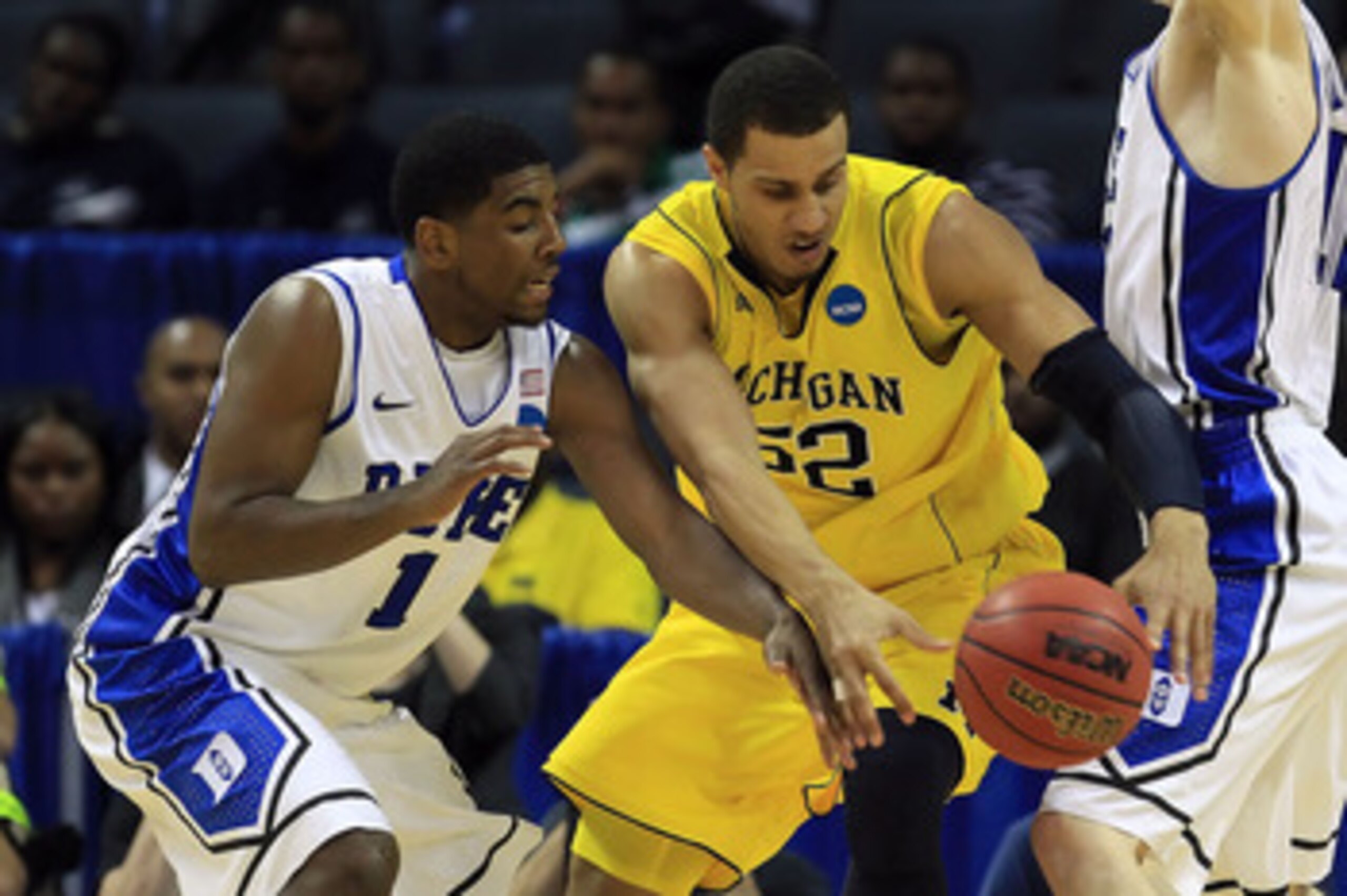 CHARLOTTE, NC - MARCH 20:  Kyrie Irving #1 of the Duke Blue Devils attempts to steal the ball from Jordan Morgan #52 of the Michigan Wolverines in the second half during the third round of the 2011 NCAA men's basketball tournament at Time Warner Cable Are