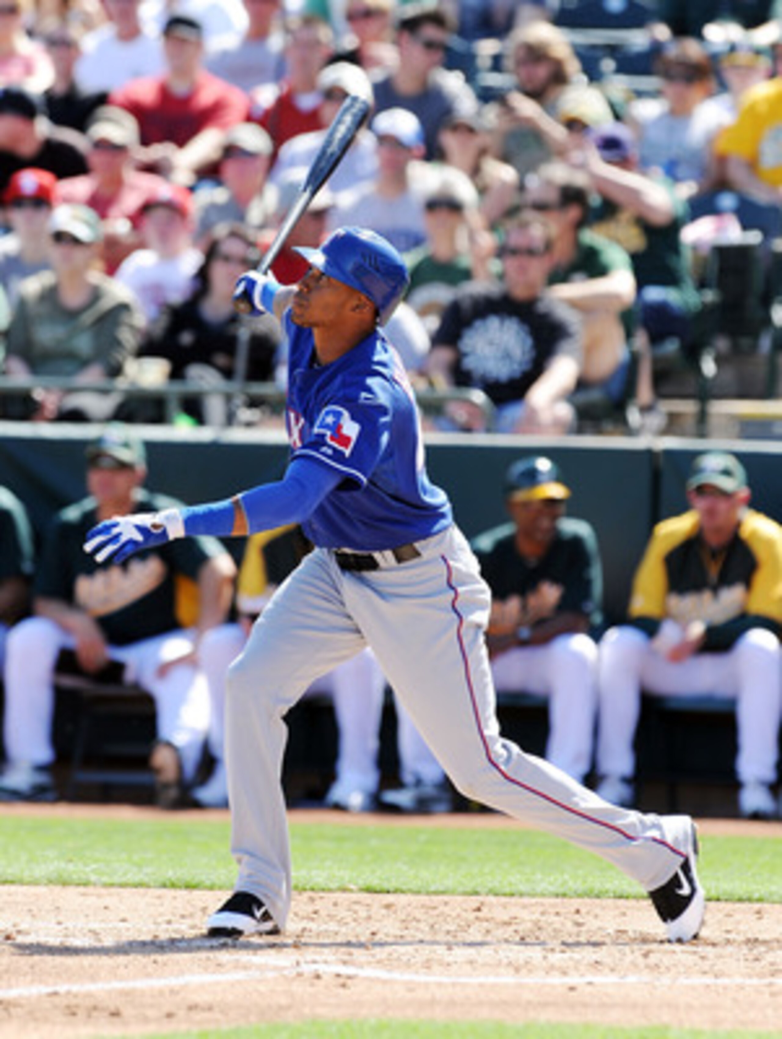 PHOENIX, AZ - MARCH 04:  Engel Beltre #43 of the Texas Rangers follows through on a swing against the Oakland Athletics at Phoenix Municipal Stadium on March 4, 2011 in Phoenix, Arizona.  (Photo by Norm Hall/Getty Images)