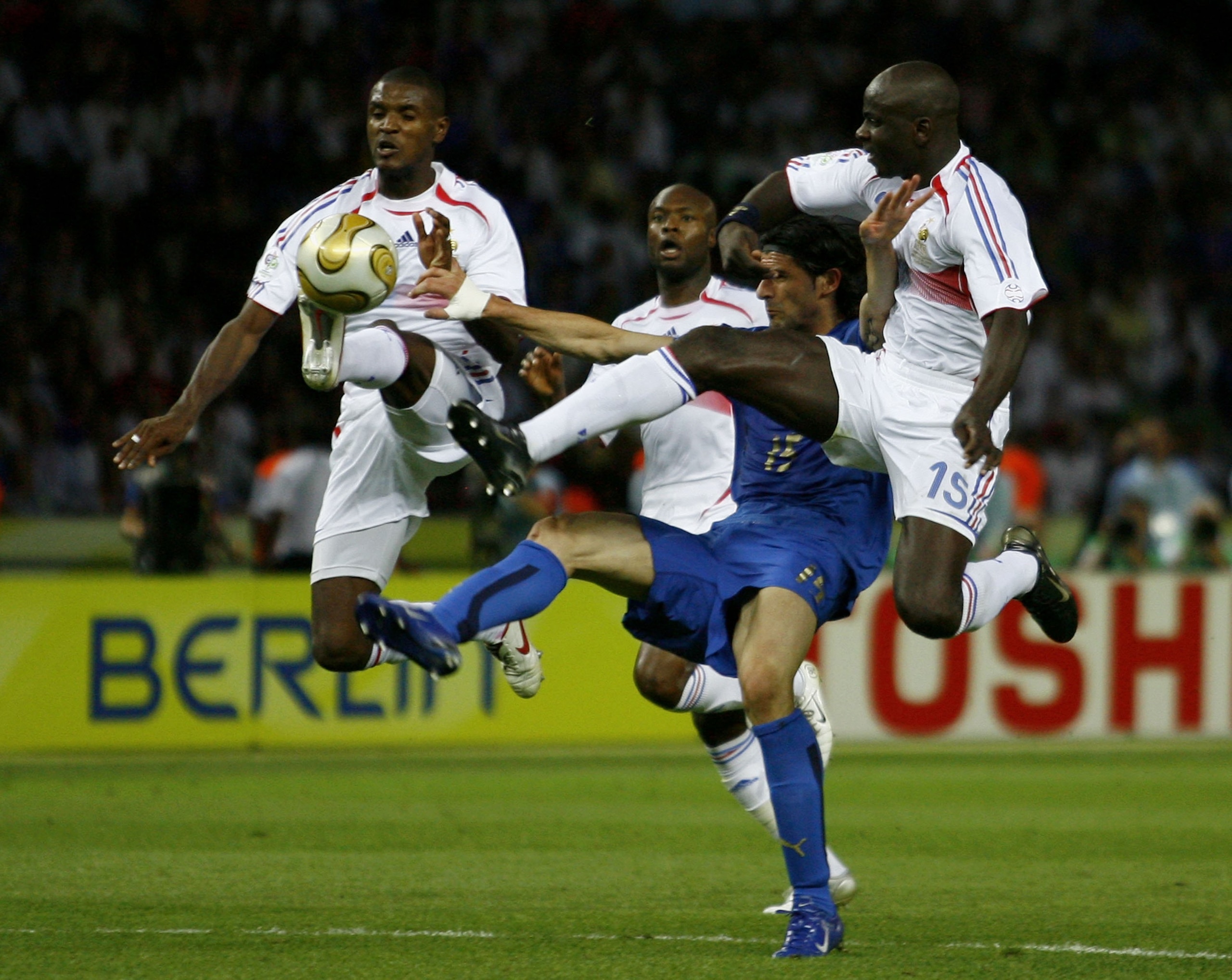 BERLIN - JULY 9: Eric Abidal (L) and Lilian Thuram (R) of France battle with Vincenzo Iaquinta (2nd R) of Italy for the ball during the FIFA World Cup Germany 2006 Final match between Italy and France at the Olympic Stadium on July 9, 2006 in Berlin, Germ