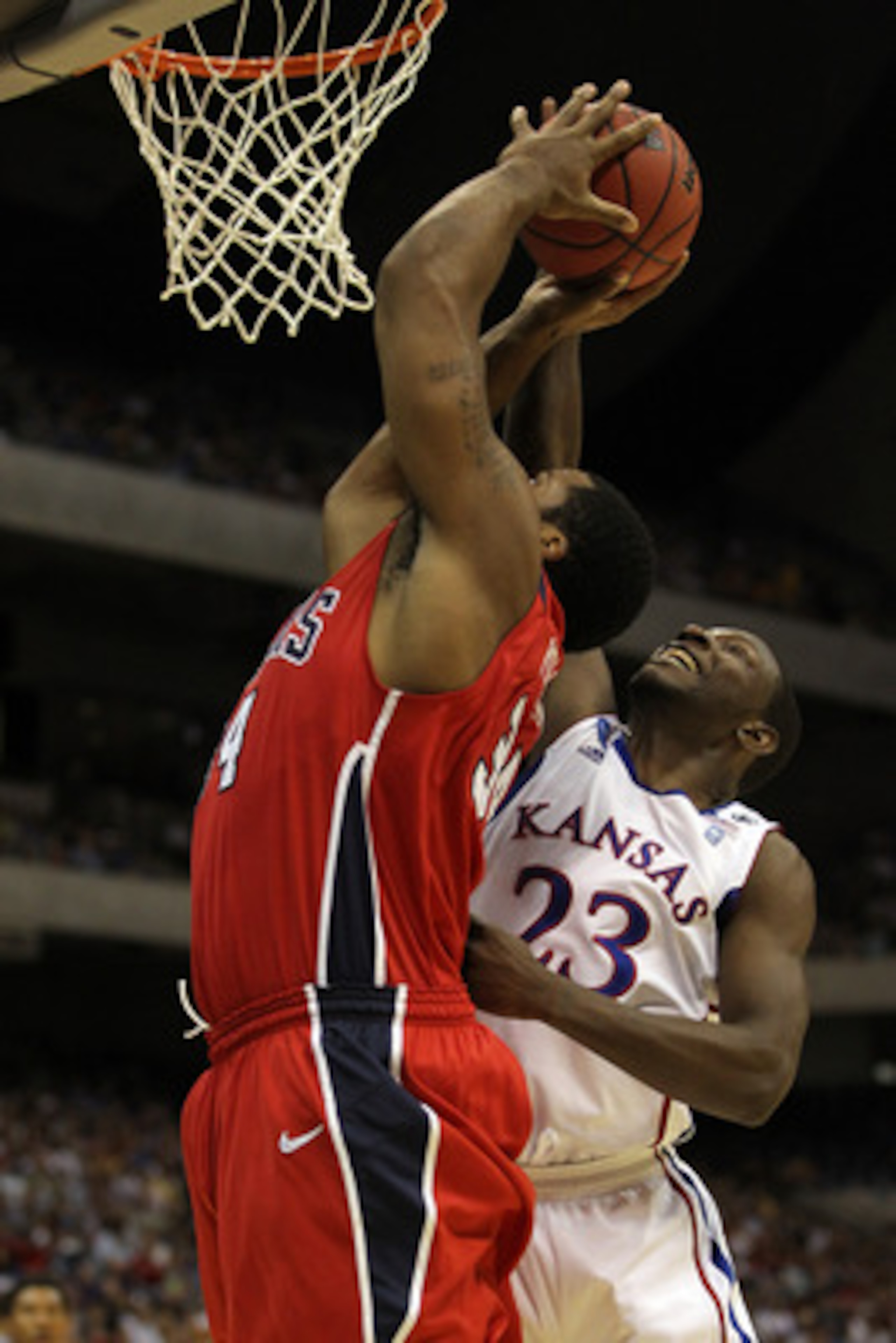 SAN ANTONIO, TX - MARCH 25:  Mario Little #23 of the Kansas Jayhawks blocks the shot by Derrick Williams #34 of the Richmond Spiders of the Richmond Spiders during the southwest regional of the 2011 NCAA men's basketball tournament at the Alamodome on Mar