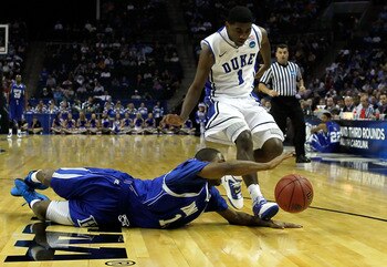 CHARLOTTE, NC - MARCH 18: Mike Tuitt #11 of the Hampton Pirates drives for the ball in front of Kyrie Irving #1 of the Duke Blue Devils in the second half during the second round of the 2011 NCAA men's basketball tournament at Time Warner Cable Arena on CHARLOTTE, NC - MARCH 18: Mike Tuitt #11 of the Hampton Pirates drives for the ball in front of Kyrie Irving #1 of the Duke Blue Devils in the second half during the second round of the 2011 NCAA men's basketball tournament at Time Warner Cable Arena on