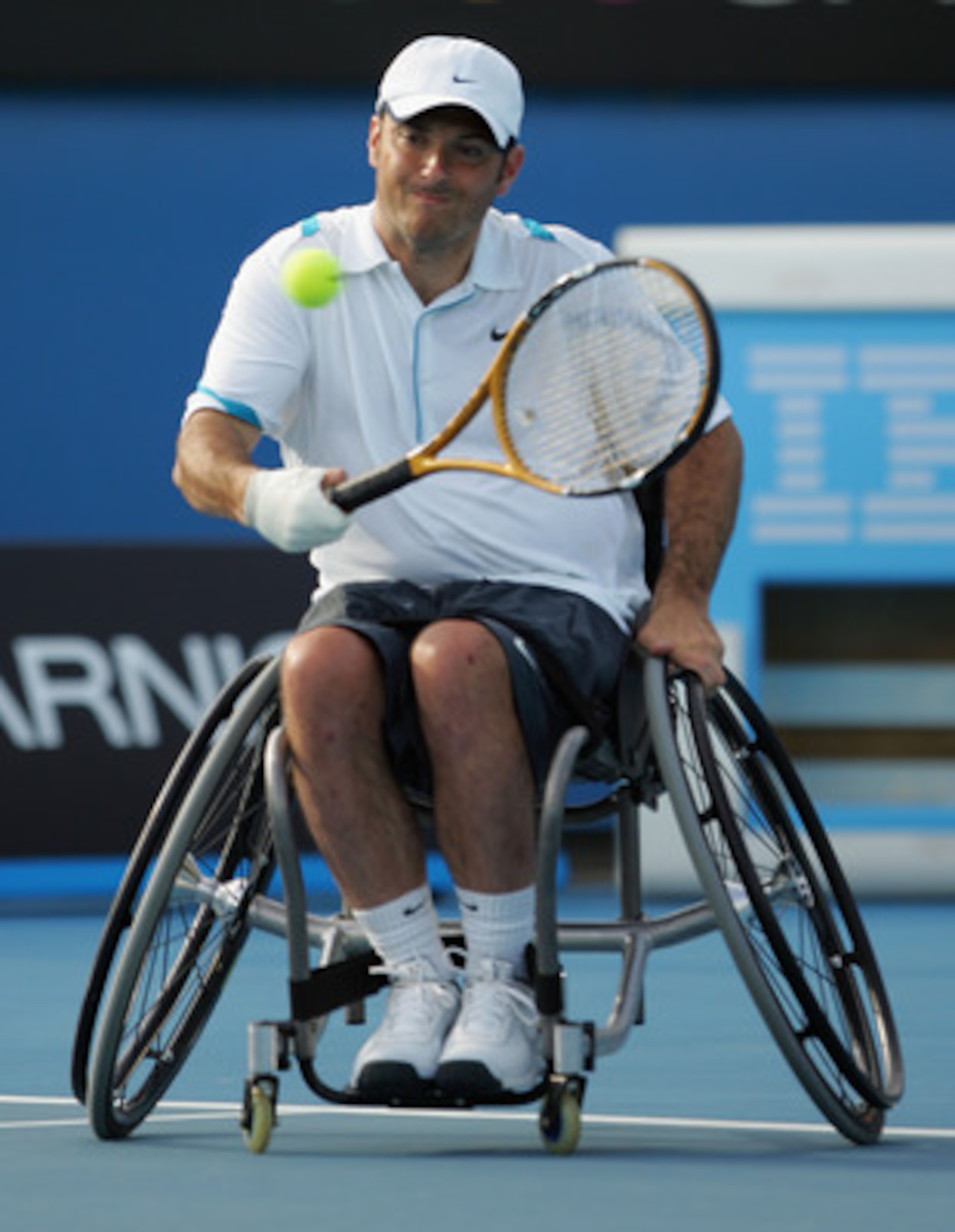 MELBOURNE, AUSTRALIA - JANUARY 31:  David Wagner of the United States of America plays a backhand in his men's quad wheelchair final match against Peter Norfolk of Great Britain during day thirteen of the 2009 Australian Open at Melbourne Park on January