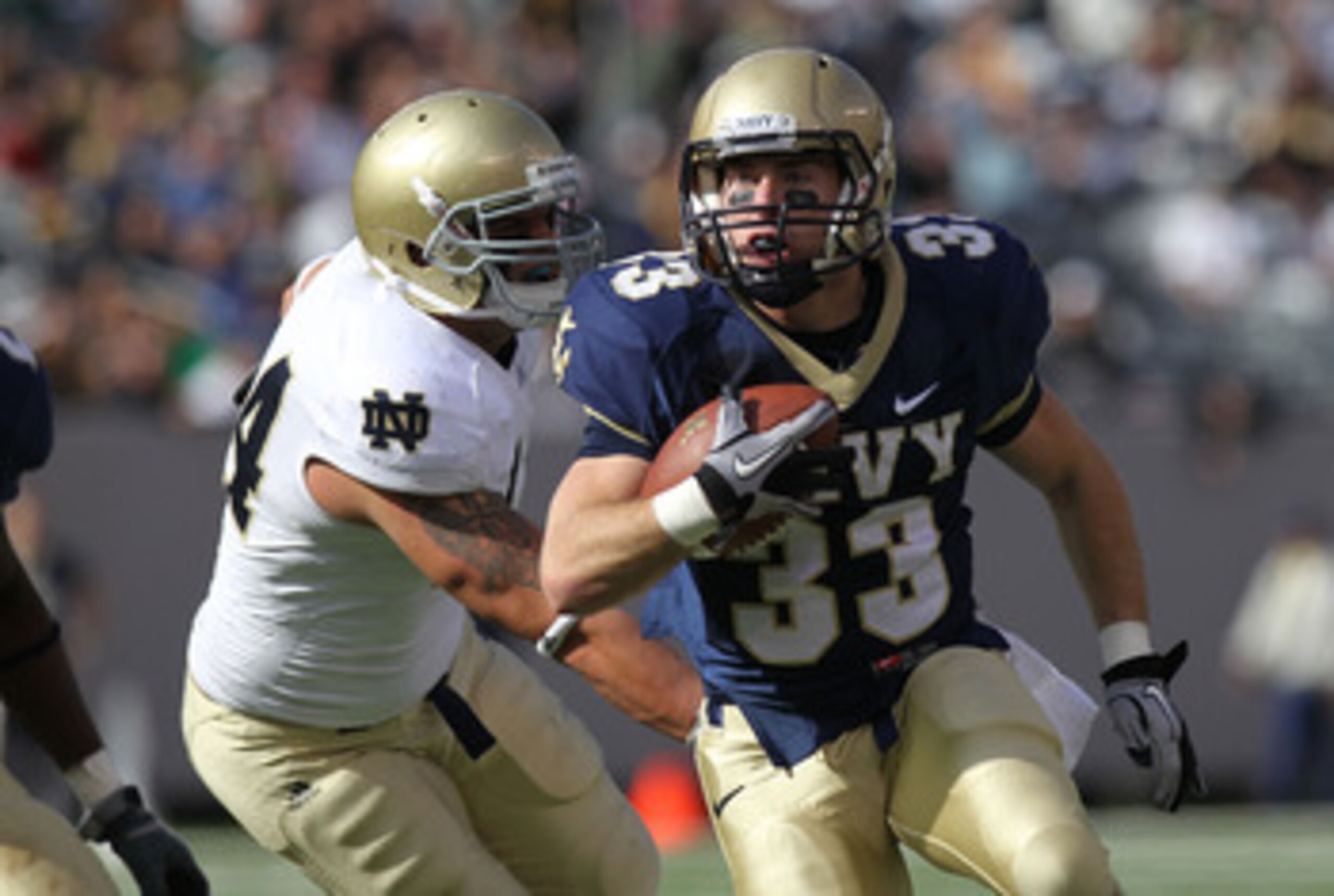 EAST RUTHERFORD, NJ - OCTOBER 23: John Howell #33 of the Navy Midshipmen rushes against the Notre Dame Fighting Irish at New Meadowlands Stadium on October 23, 2010 in East Rutherford, New Jersey.  (Photo by Nick Laham/Getty Images)