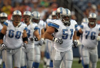 DENVER - AUGUST 21:  Center Dominic Raiola #51 of the Detroit Lions leads his team onto the field to face the Denver Broncos during preseason NFL action at INVESCO Field at Mile High on August 21, 2010 in Denver, Colorado. The Lions defeated the Broncos 2