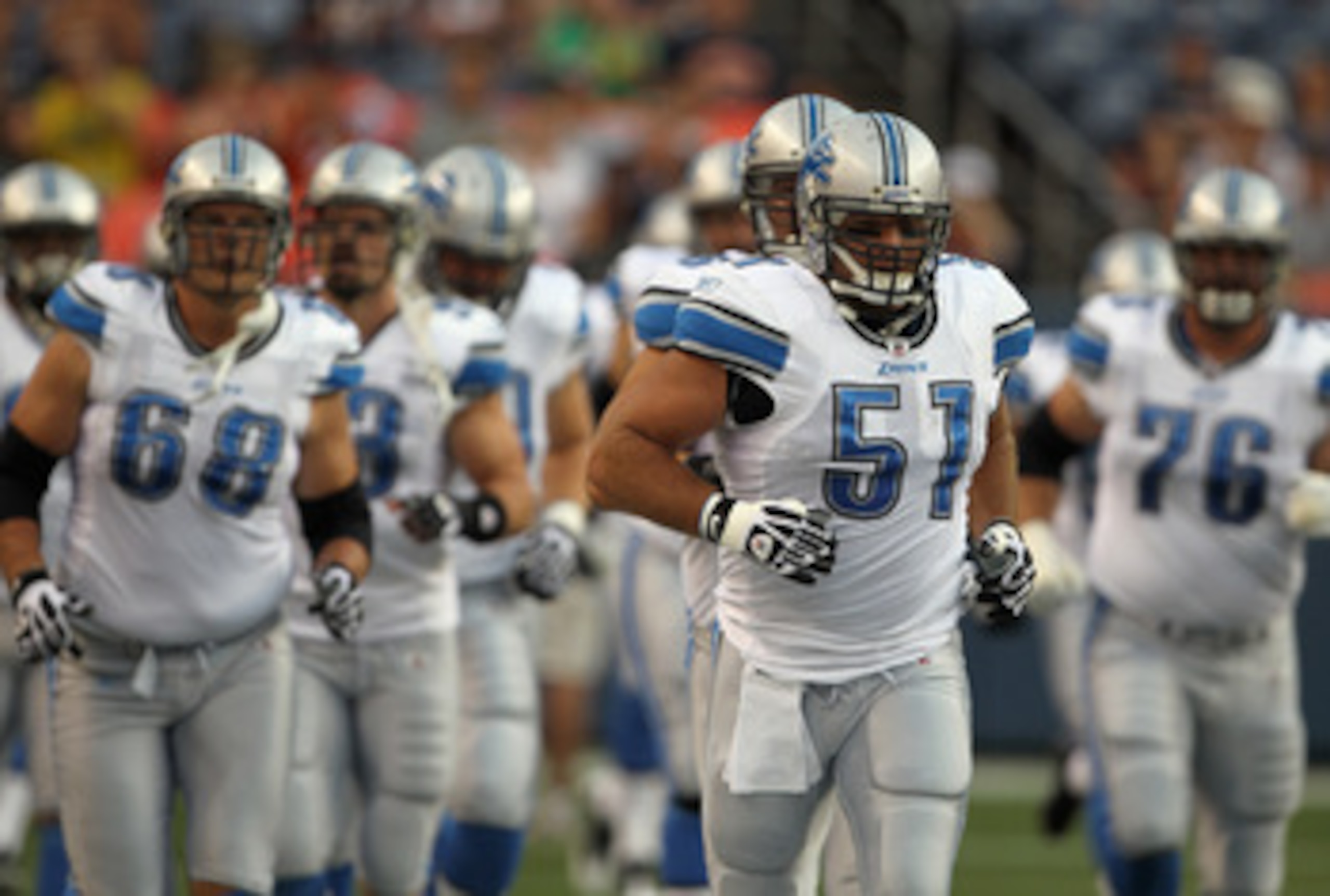 DENVER - AUGUST 21:  Center Dominic Raiola #51 of the Detroit Lions leads his team onto the field to face the Denver Broncos during preseason NFL action at INVESCO Field at Mile High on August 21, 2010 in Denver, Colorado. The Lions defeated the Broncos 2