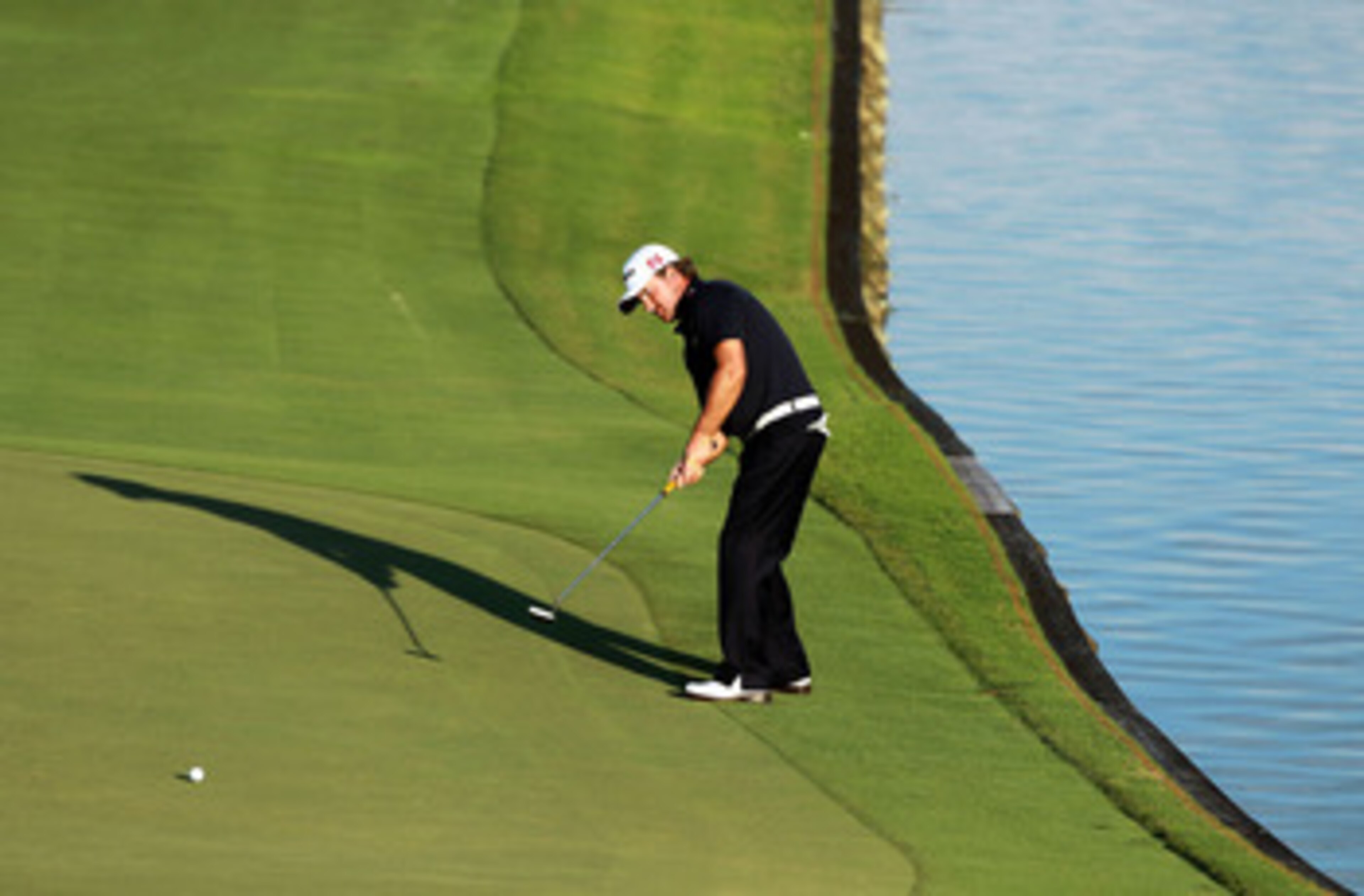 PONTE VEDRA BEACH, FL - MAY 15:  Graeme McDowell of Northern Ireland putts on the 18th hole during the final round of THE PLAYERS Championship held at THE PLAYERS Stadium course at TPC Sawgrass on May 15, 2011 in Ponte Vedra Beach, Florida.  (Photo by Sco