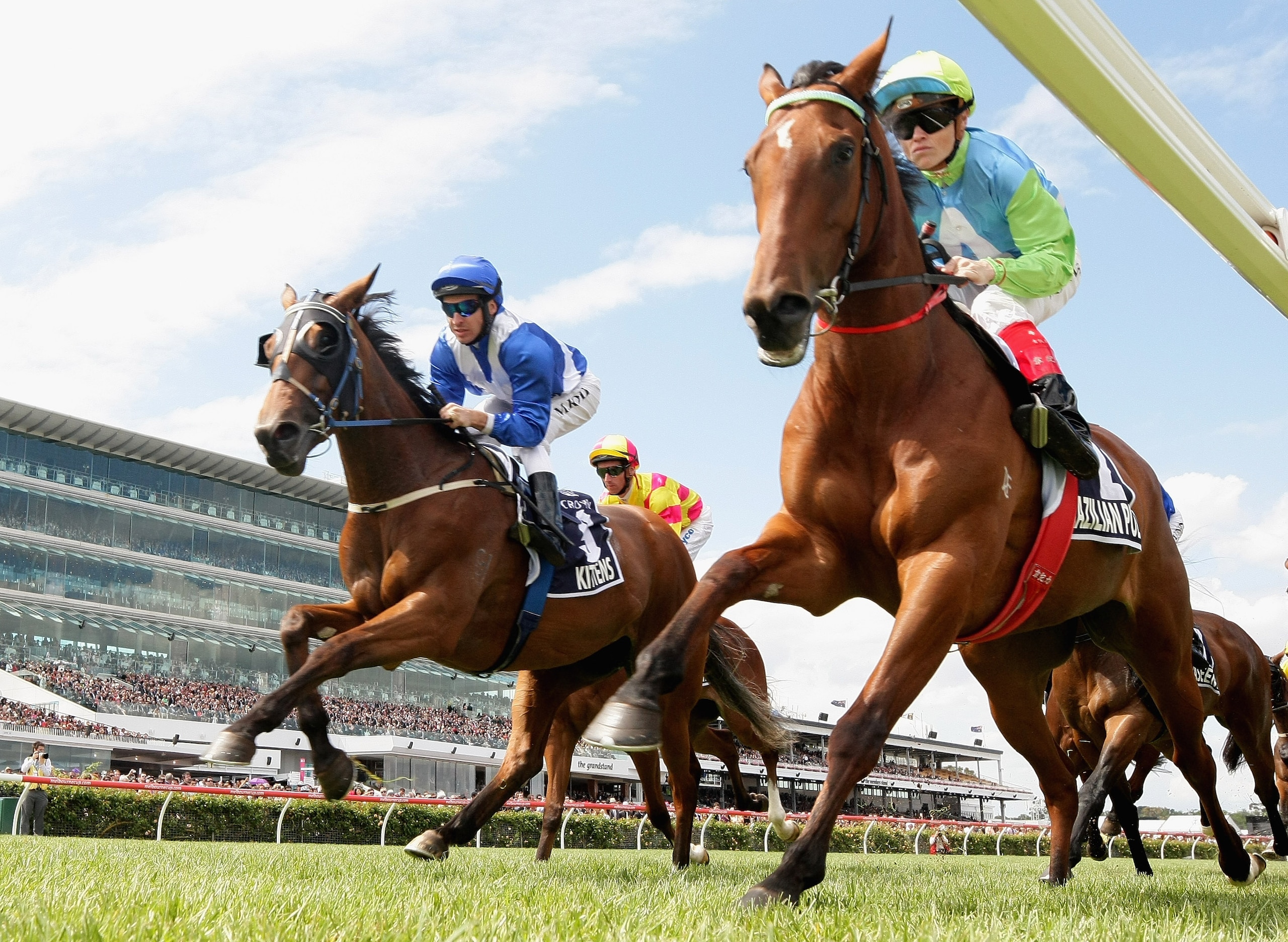 MELBOURNE, AUSTRALIA - NOVEMBER 04:  Jockey Craig Williams riding Brazilian Pulse and Michael Rodd riding Kittens lead the field past the finishing post the first time in Race Six the Crown Oaks during Crown Oaks Day at Flemington Racecourse on November 4