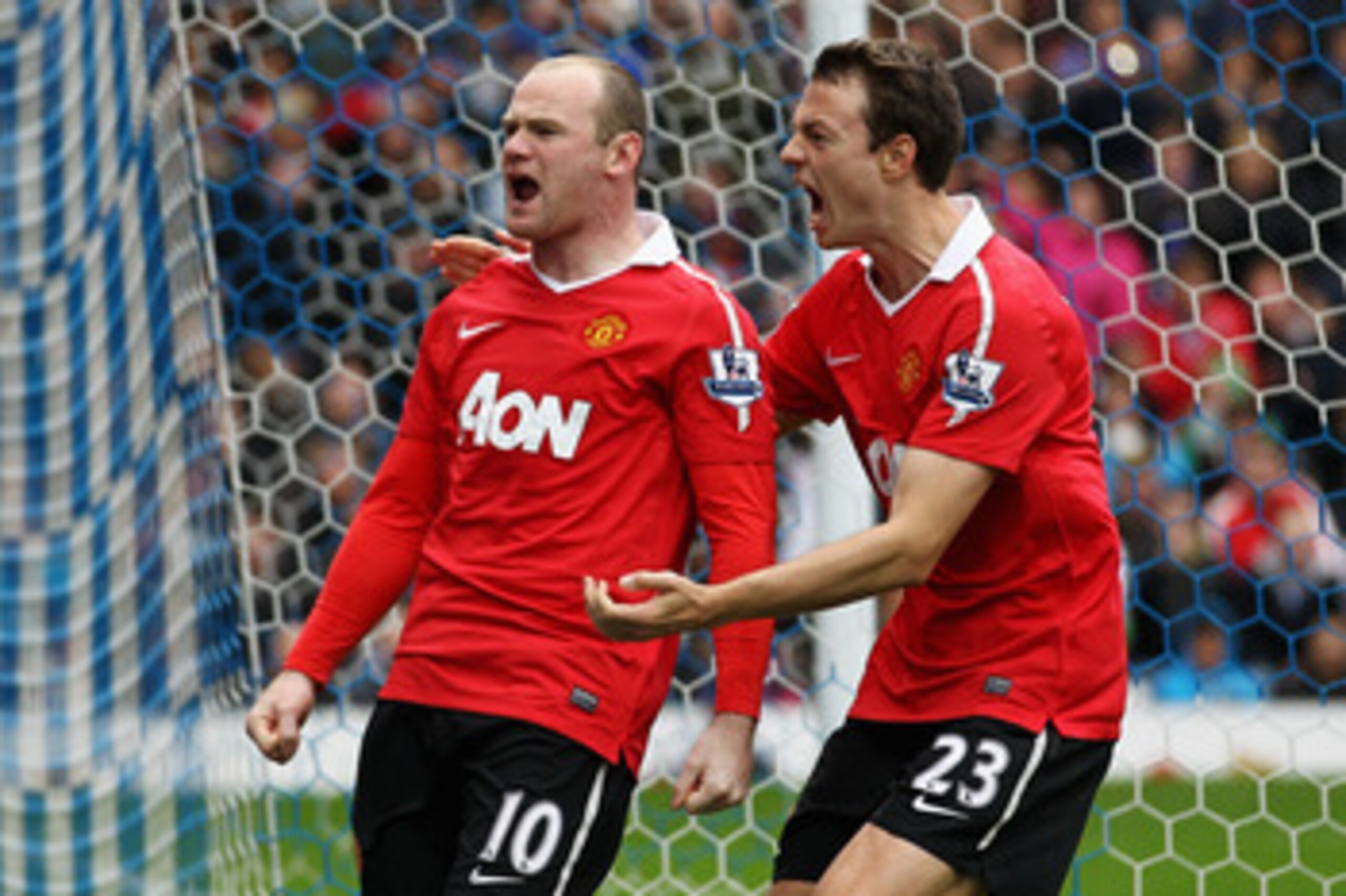 BLACKBURN, ENGLAND - MAY 14:  Wayne Rooney (#10) of Manchester United celebrates with team mate Jonny Evans after scoring a penalty during the Barclays Premier League match between Blackburn Rovers and Manchester United at Ewood park on May 14, 2011 in Bl