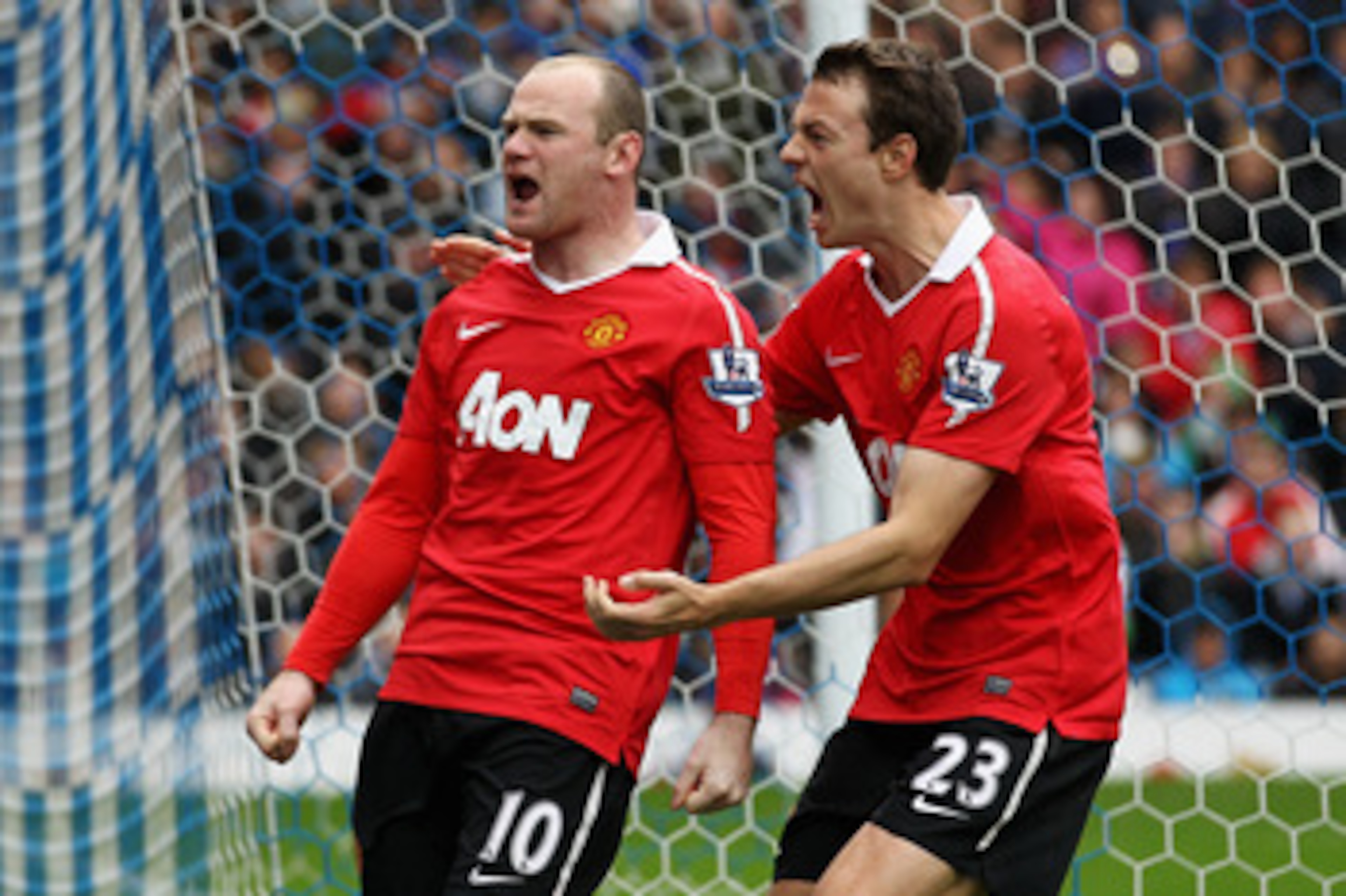 BLACKBURN, ENGLAND - MAY 14:  Wayne Rooney (#10) of Manchester United celebrates with team mate Jonny Evans after scoring a penalty during the Barclays Premier League match between Blackburn Rovers and Manchester United at Ewood park on May 14, 2011 in Bl