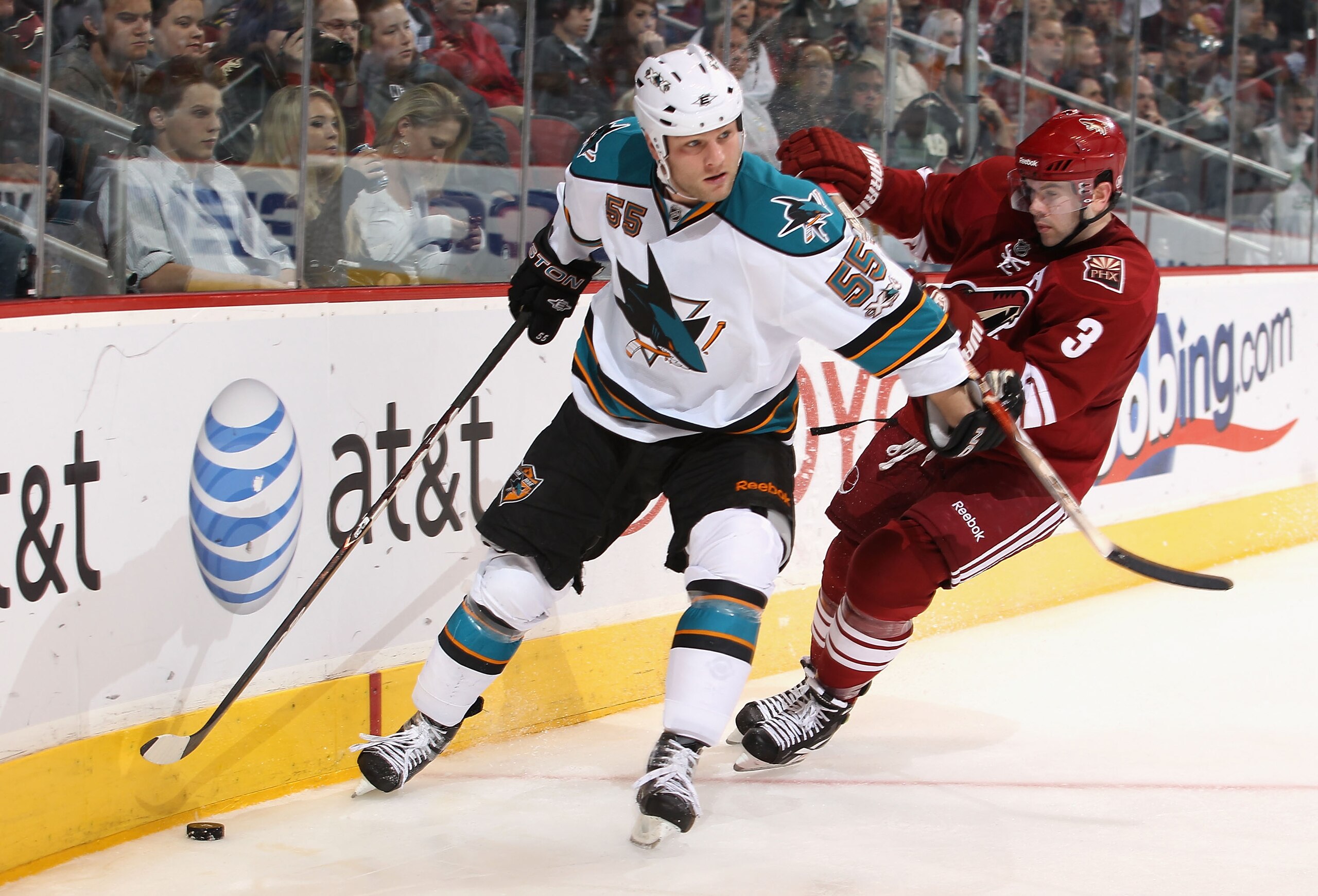 GLENDALE, AZ - MARCH 26:  Ben Eager #55 of the San Jose Sharks skates with the puck past Keith Yandle #3 of the Phoenix Coyotes during the NHL game at Jobing.com Arena on March 26, 2011 in Glendale, Arizona.  The Sharks defeated the Coyotes 4-1. (Photo by