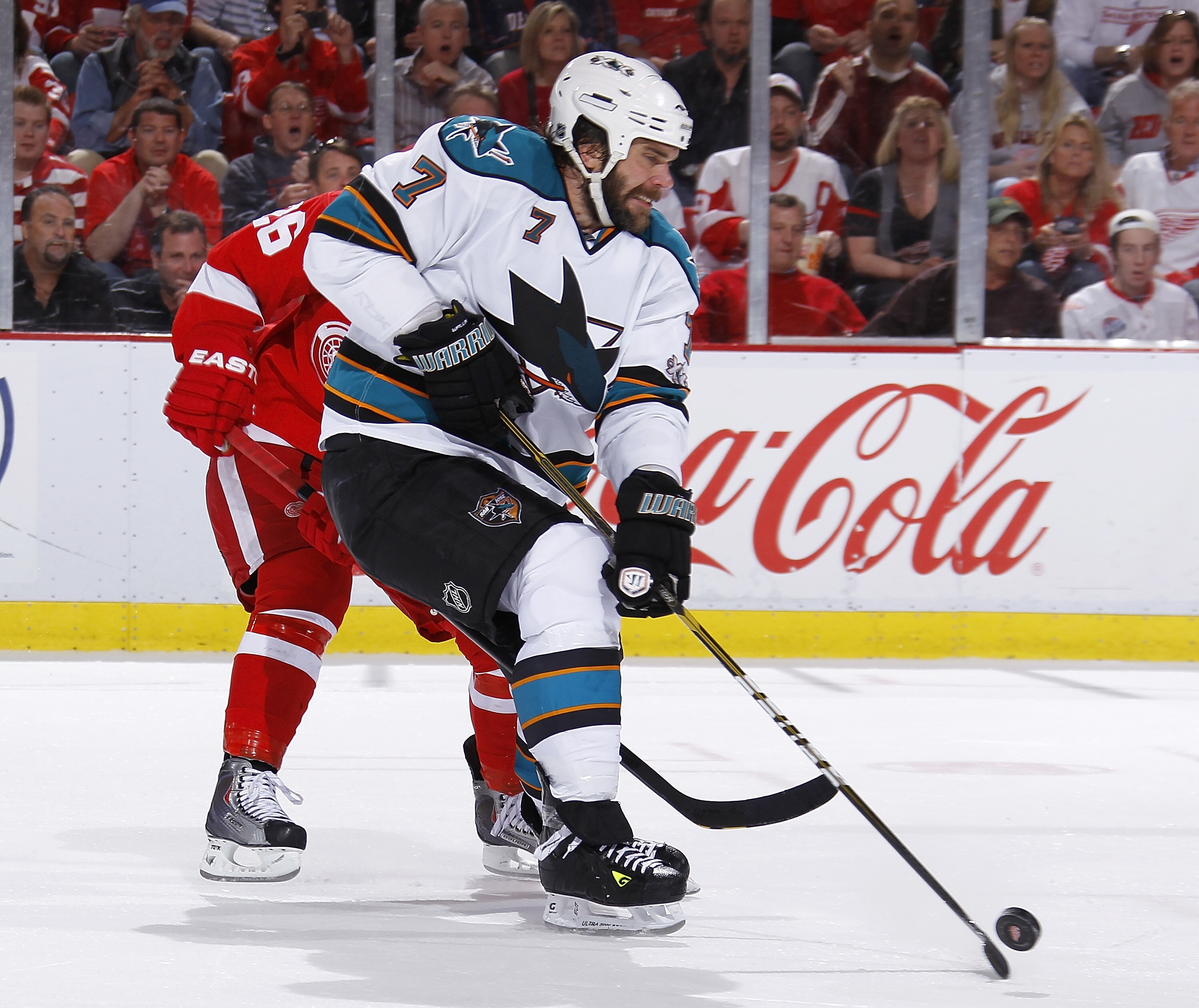 DETROIT - MAY 10: Niclas Wallin #7 of the San Jose Sharks controls the puck in front of Jiri Hudler #26 of the Detroit Red Wings during the second period in Game Six of the Western Conference Semifinals during the 2011 NHL Stanley Cup Playoffs on May 10,