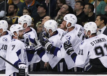 BOSTON, MA - MAY 14:  Brett Clark #7 of the Tampa Bay Lightning celebrates his first period goal against the Boston Bruins with teammates in Game One of the Eastern Conference Finals during the 2011 NHL Stanley Cup Playoffs at TD Garden on May 14, 2011 in