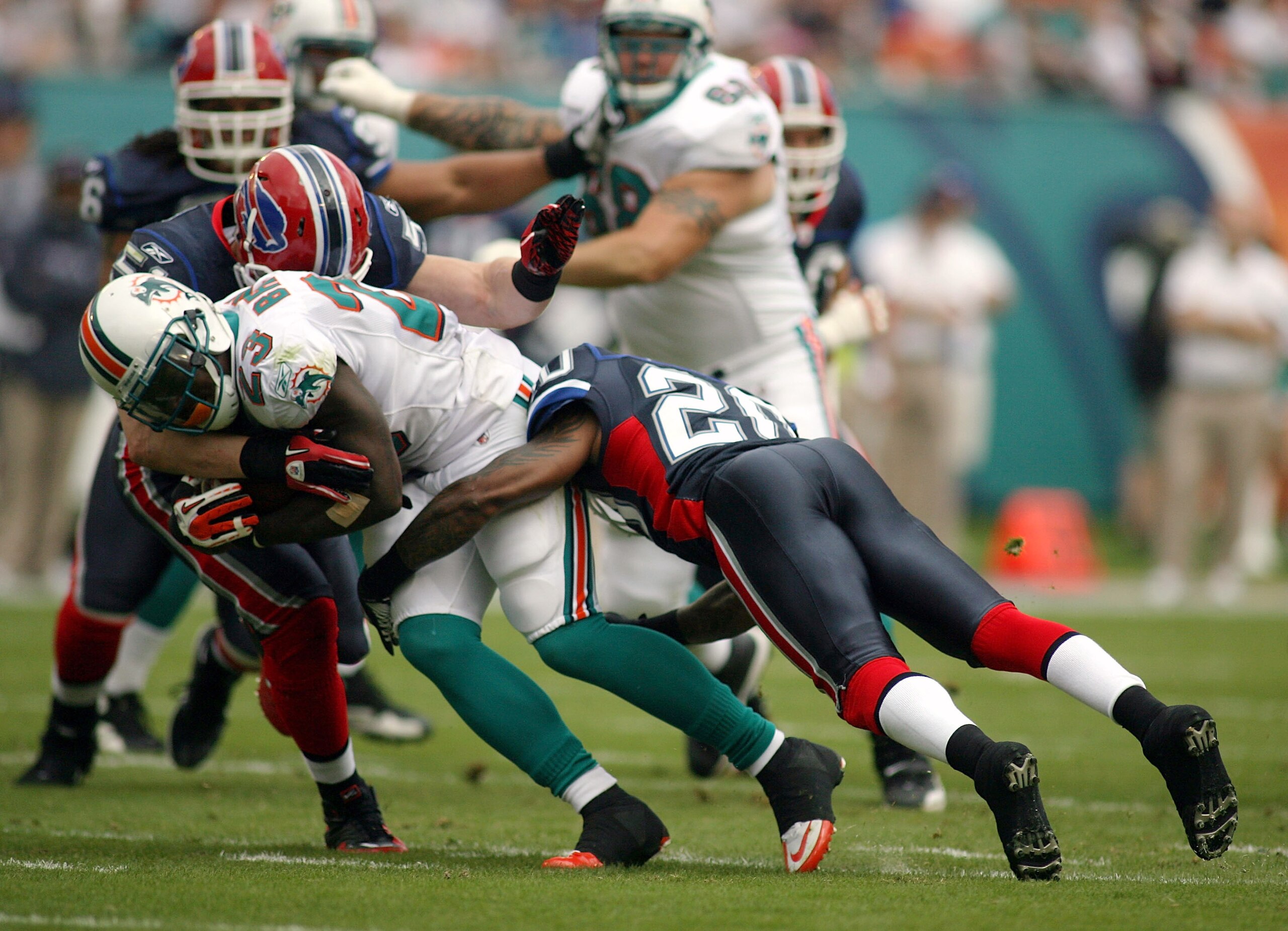 MIAMI, FL - DECEMBER 19: Tight end Anthony Fasano #80 of the Miami Dolphins is upended by cornerback Donte Whitner #20 of the Buffalo Bills during a game at Sun Life Stadium on December 19, 2010 in Miami, Florida.  (Photo by Marc Serota/Getty Images)